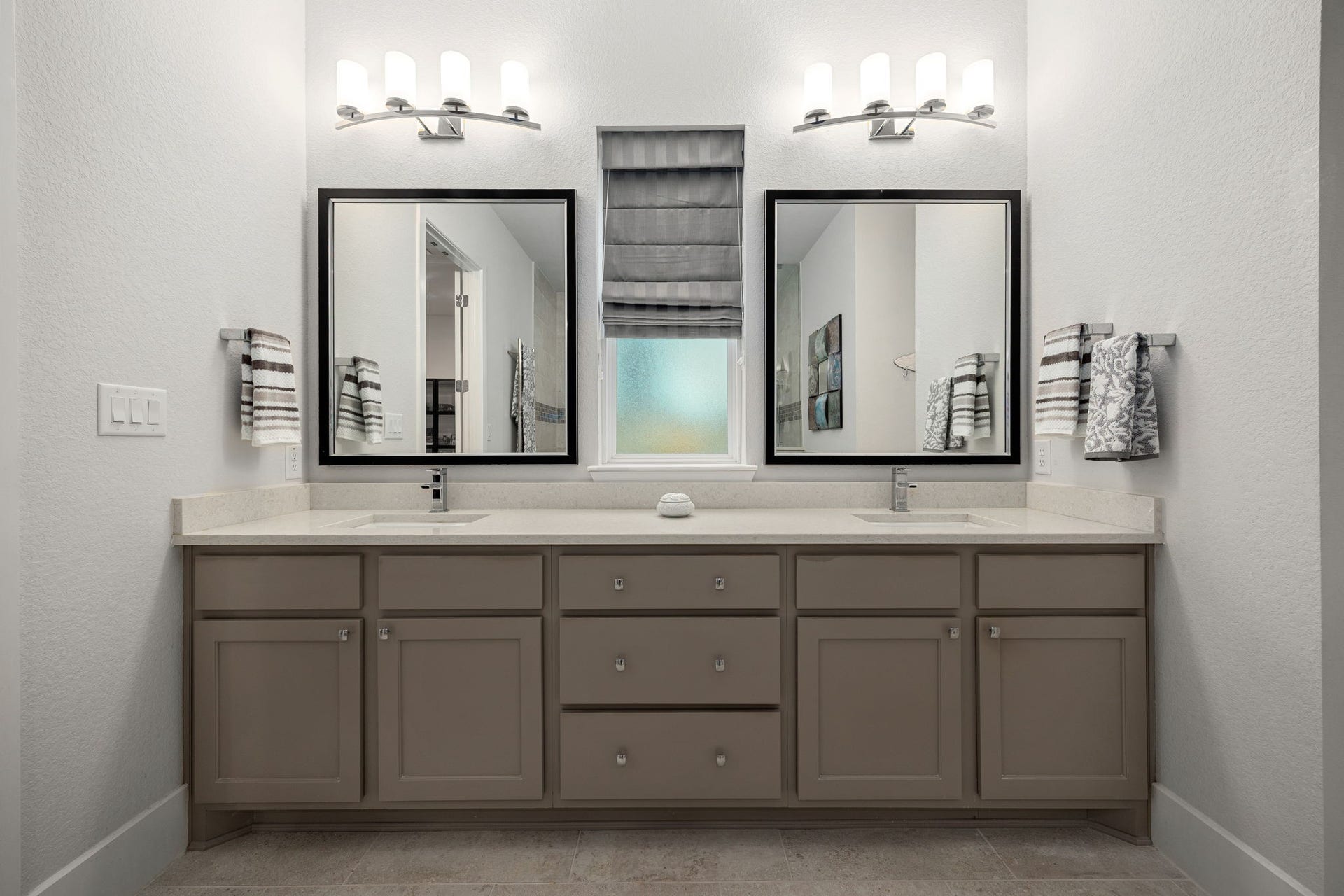 18 Gentle Branch Place, The Woodlands, TX 77375 Elevate your morning routine with this expansive double vanity featuring abundant storage, sleek stone countertops, and dual undermount sinks. Sophisticated designer mirrors and contemporary lighting fixtures complete this polished, functional space in the primary ensuite.