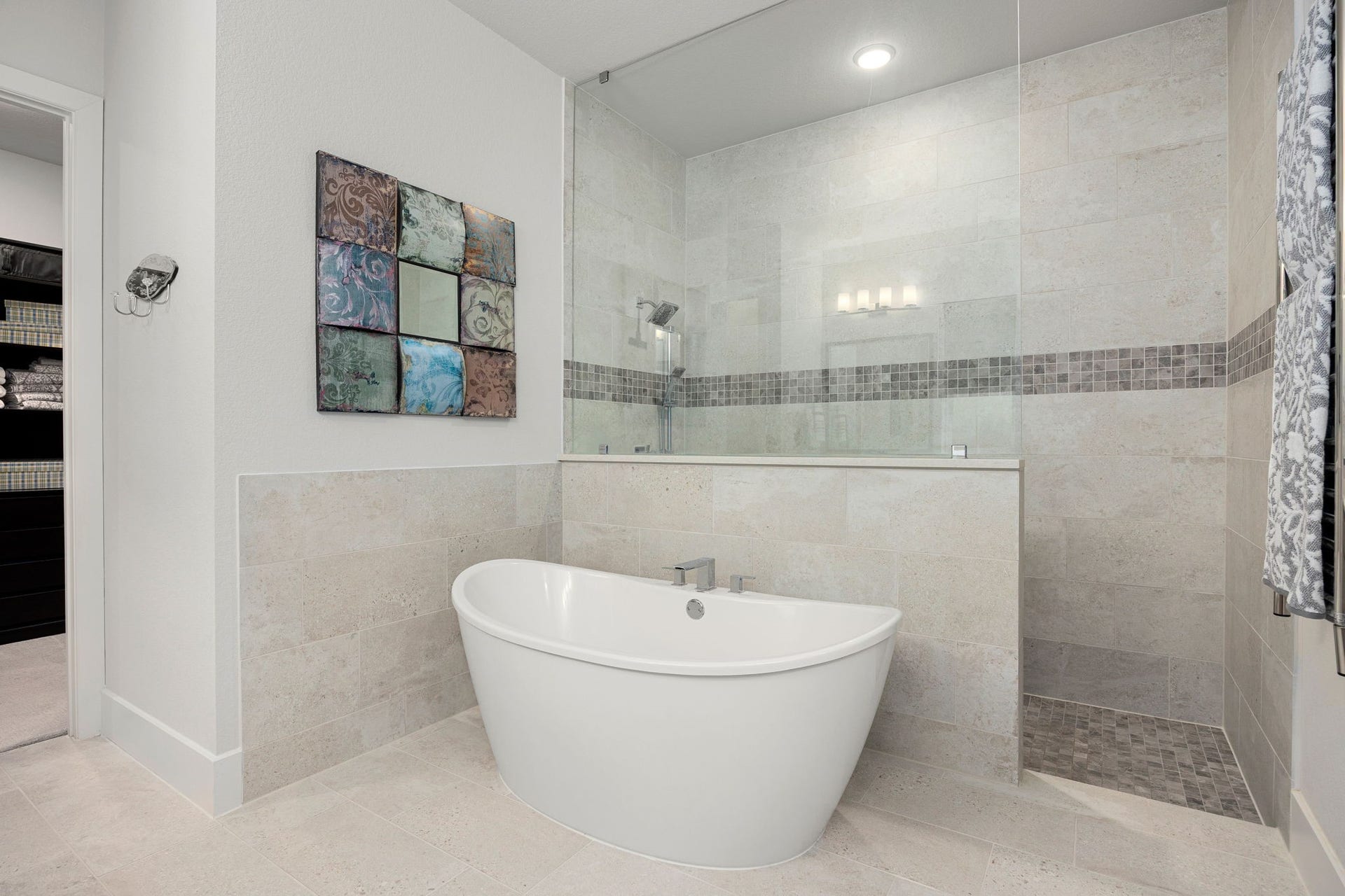 18 Gentle Branch Place, The Woodlands, TX 77375 Relax and recharge in the stunning primary ensuite, anchored by a sleek freestanding soaking tub and a massive, glass-enclosed walk-in shower with designer tile accents. The clean lines and tranquil color palette create a refined, hotel-inspired retreat right at home.