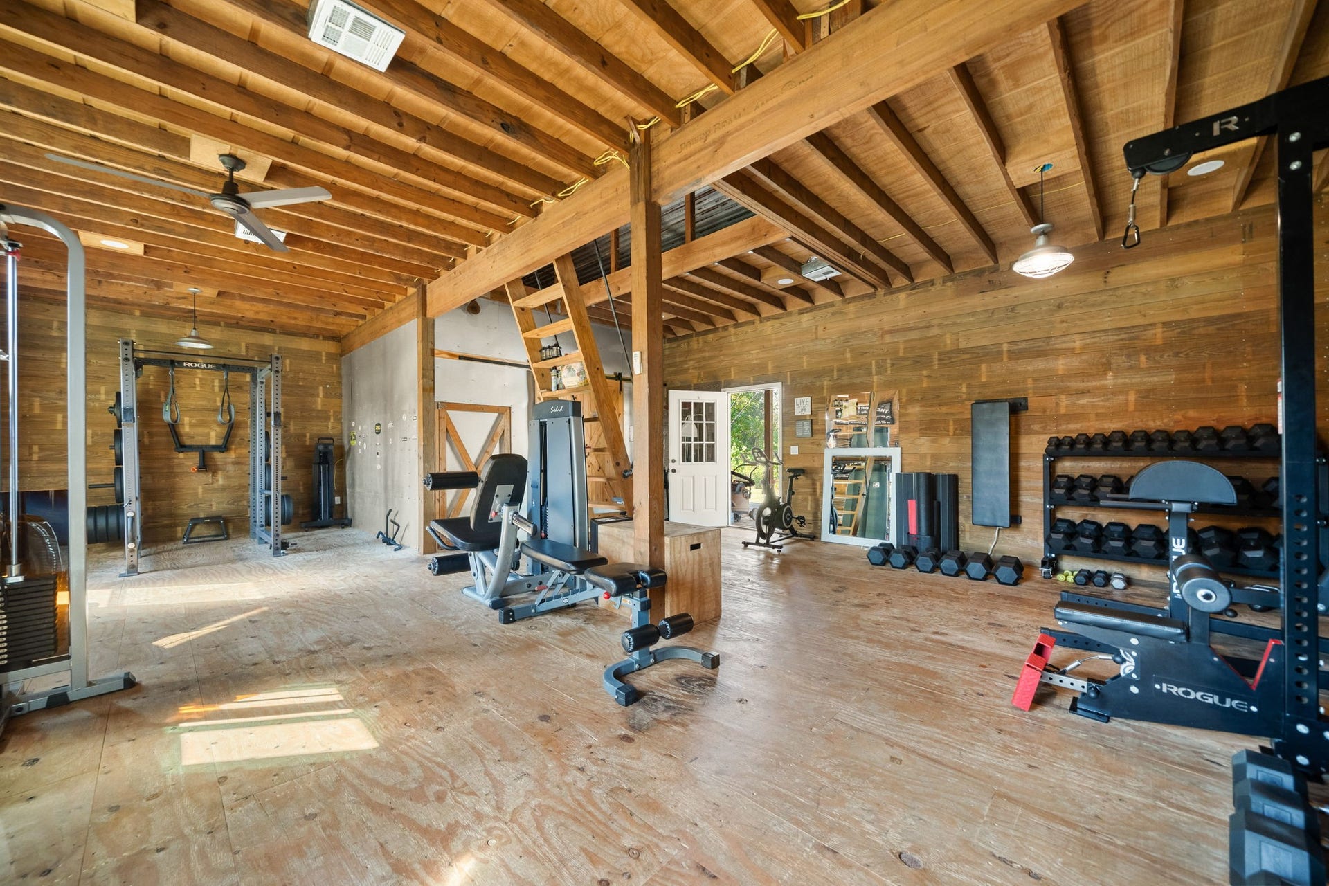 6571 Manorwood Drive, Katy, TX 77493 Repurposed with meticulous attention to detail, this expansive barn-turned-gym pairs rustic wood aesthetics with modern training demands. Featuring towering exposed timber ceilings, resilient plywood flooring, and an abundance of functional floor space, it provides the perfect backdrop for elite workouts, personal training, or your dream wellness studio.
