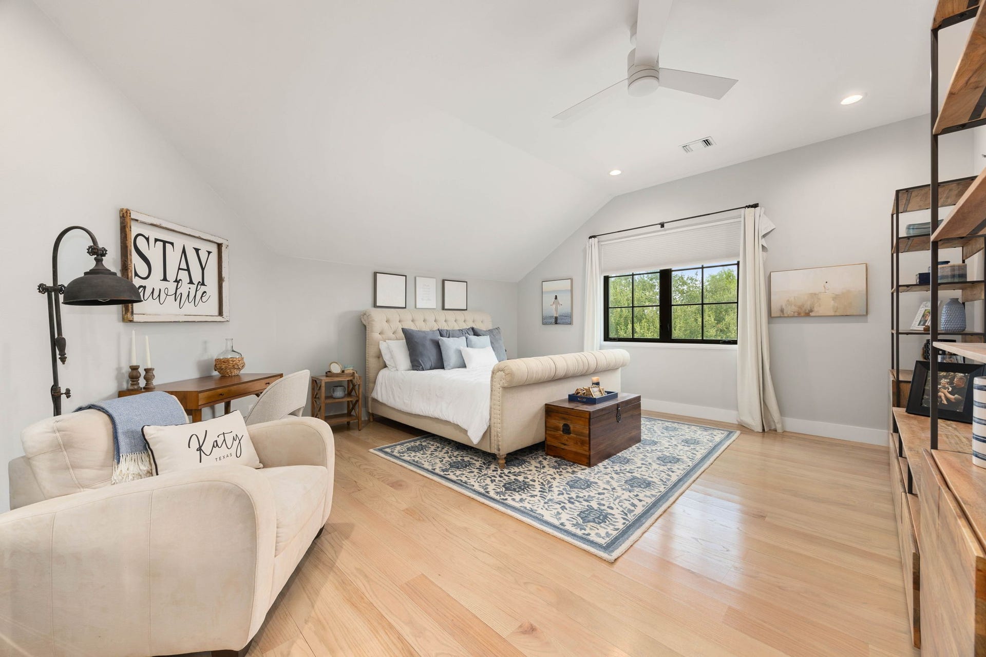 6571 Manorwood Drive, Katy, TX 77493 This massive upstairs 2nd primary suite features a beautiful vaulted ceiling design with a modern ceiling fan, recessed lighting, and a private en-suite full bathroom.