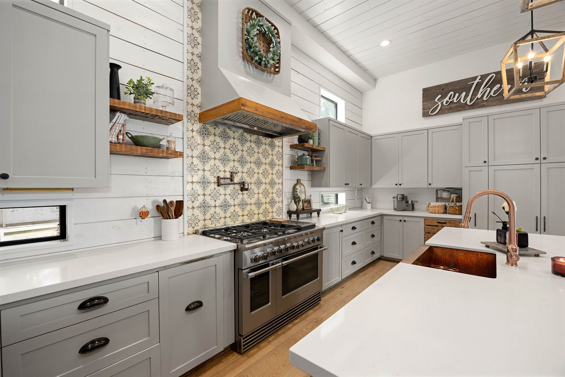 6571 Manorwood Drive, Katy, TX 77493 This exquisite cooking station features shiplap walls and ceilings, a commercial-grade Fisher & Paykel double-oven range set against a beautiful custom pattern-tile backsplash and equipped with a convenient wall-mounted pot filler.