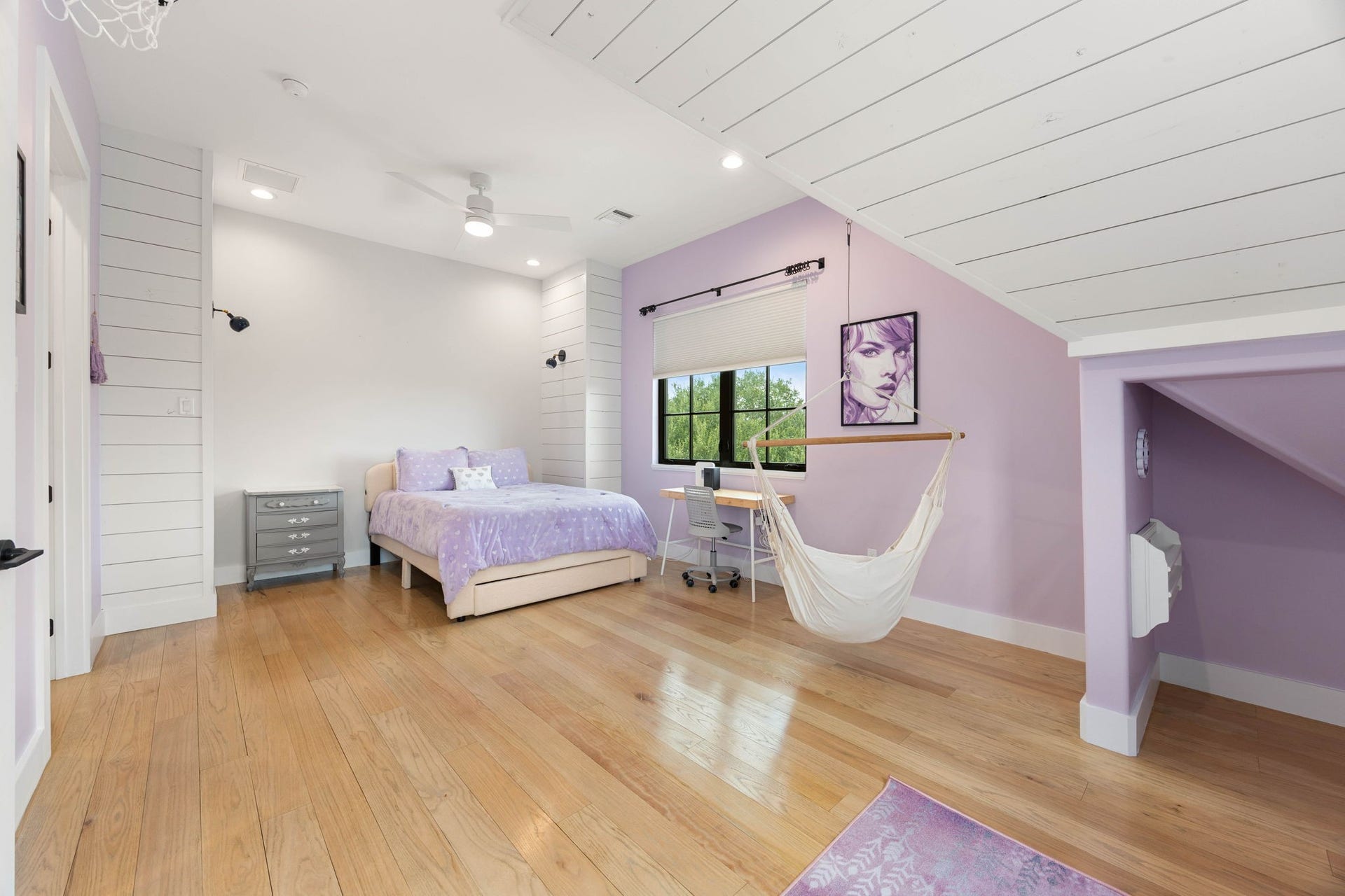 6571 Manorwood Drive, Katy, TX 77493 Mirroring the layout across the hall, this expansive bedroom features matching sloped shiplap plank ceilings and a clever, integrated structural alcove built under the staircase framing.