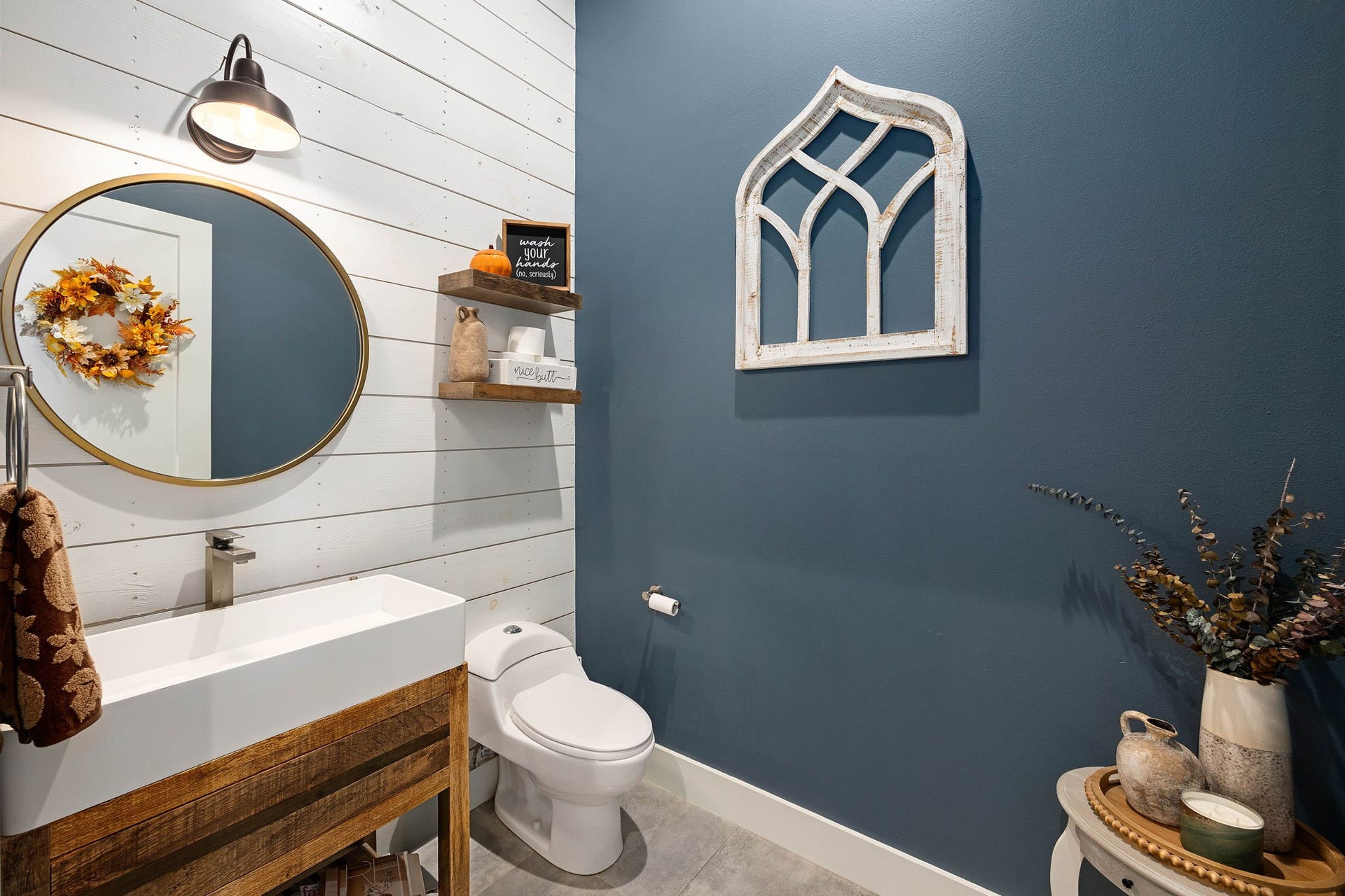 6571 Manorwood Drive, Katy, TX 77493 Clean geometric lines from the linear trough sink contrast beautifully with warm natural wood textures and crisp trim work to create a highly inviting guest bathroom.