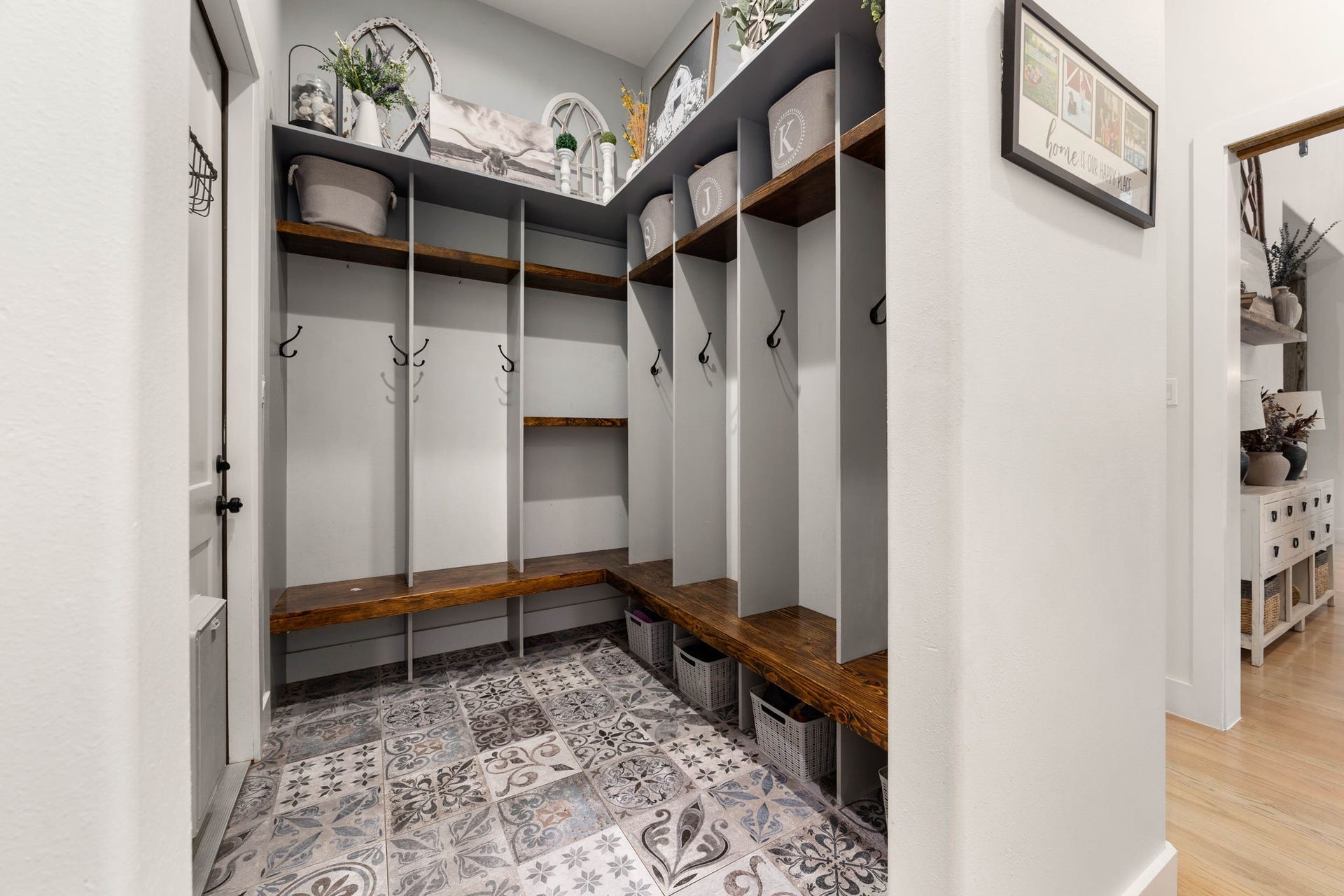 6571 Manorwood Drive, Katy, TX 77493 Tucked away near the secondary entrance, this mud room is an organizational hub boasting gorgeous patterned tile flooring that is both durable and stylish, offering plenty of space for family gear.