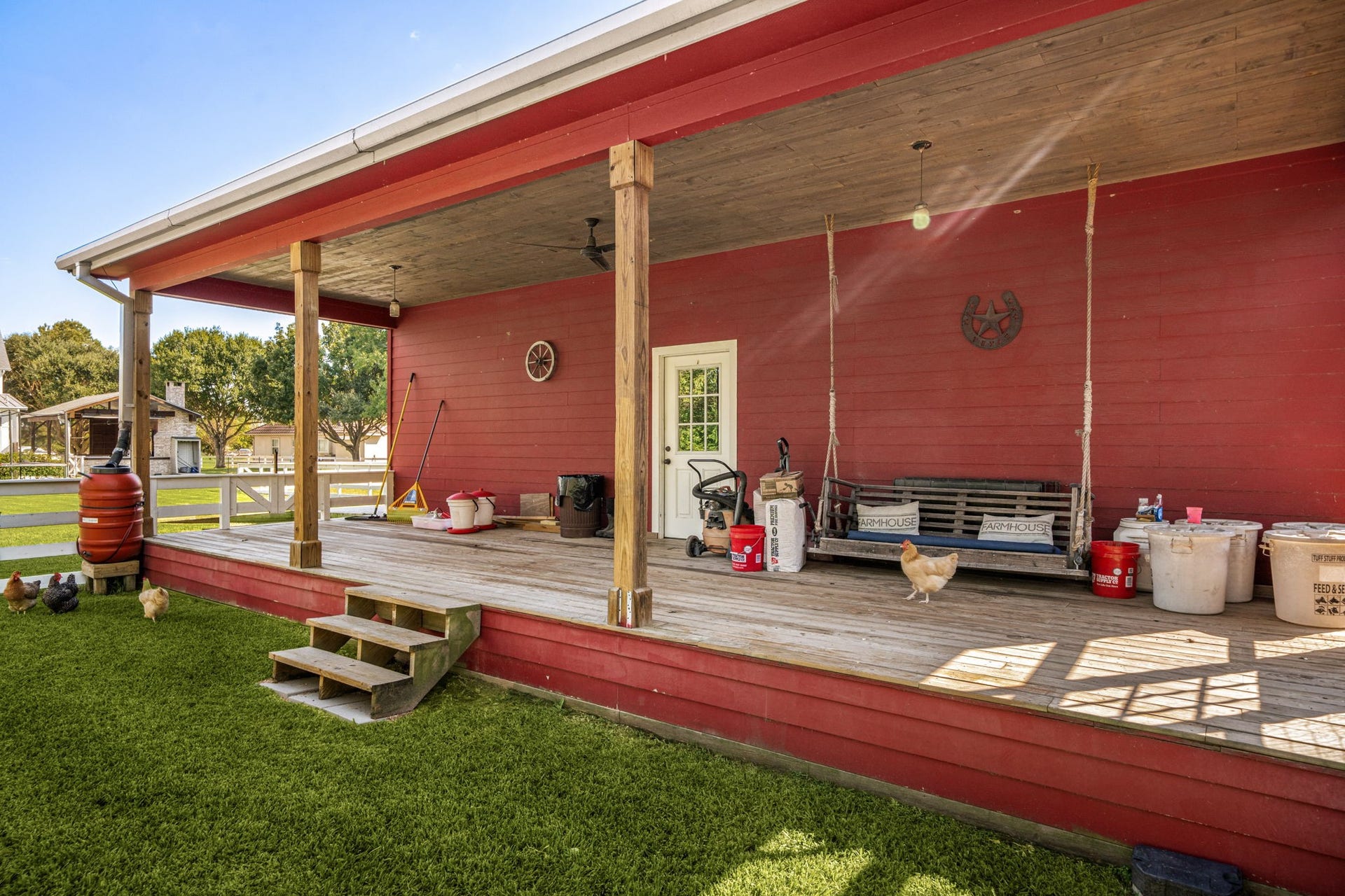 6571 Manorwood Drive, Katy, TX 77493 A striking red estate insulated barn featuring an airconditioned gym, a spacious covered deck, integrated utility stations, and concrete workspace surroundsfully equipped for hobbies, horses, or a home workshop.