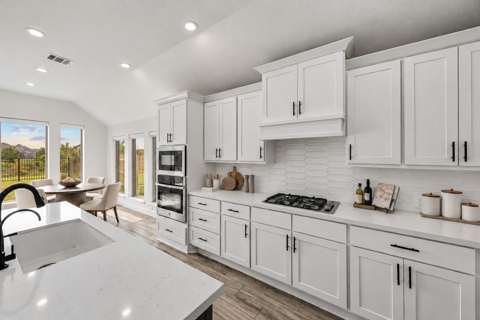 24919 Hibiscus Garden Way, Katy, TX 77493 Virtually Staged: Designed with impressive spatial flow, this open kitchen features extensive solid-surface expanses and architectural tile finishes under high, sloping ceilings.