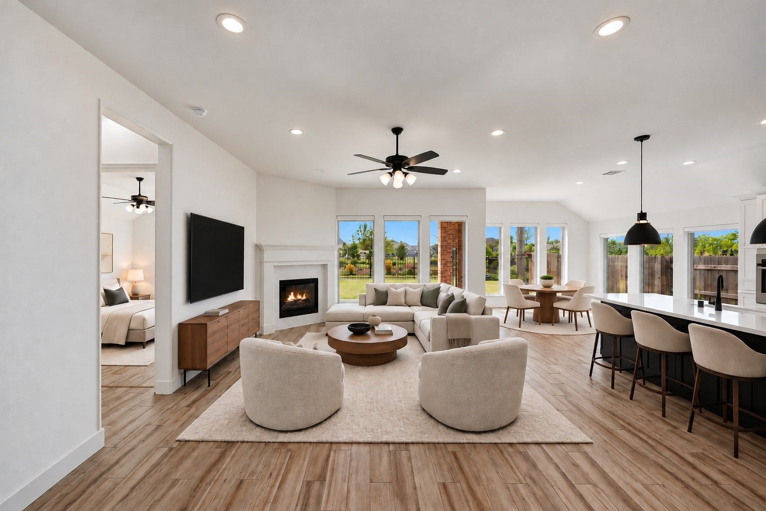 24919 Hibiscus Garden Way, Katy, TX 77493 Virtually Staged: Substantial ceiling height and expansive wall-to-wall expanses define this luminous central space, anchored by an integrated fireplace.
