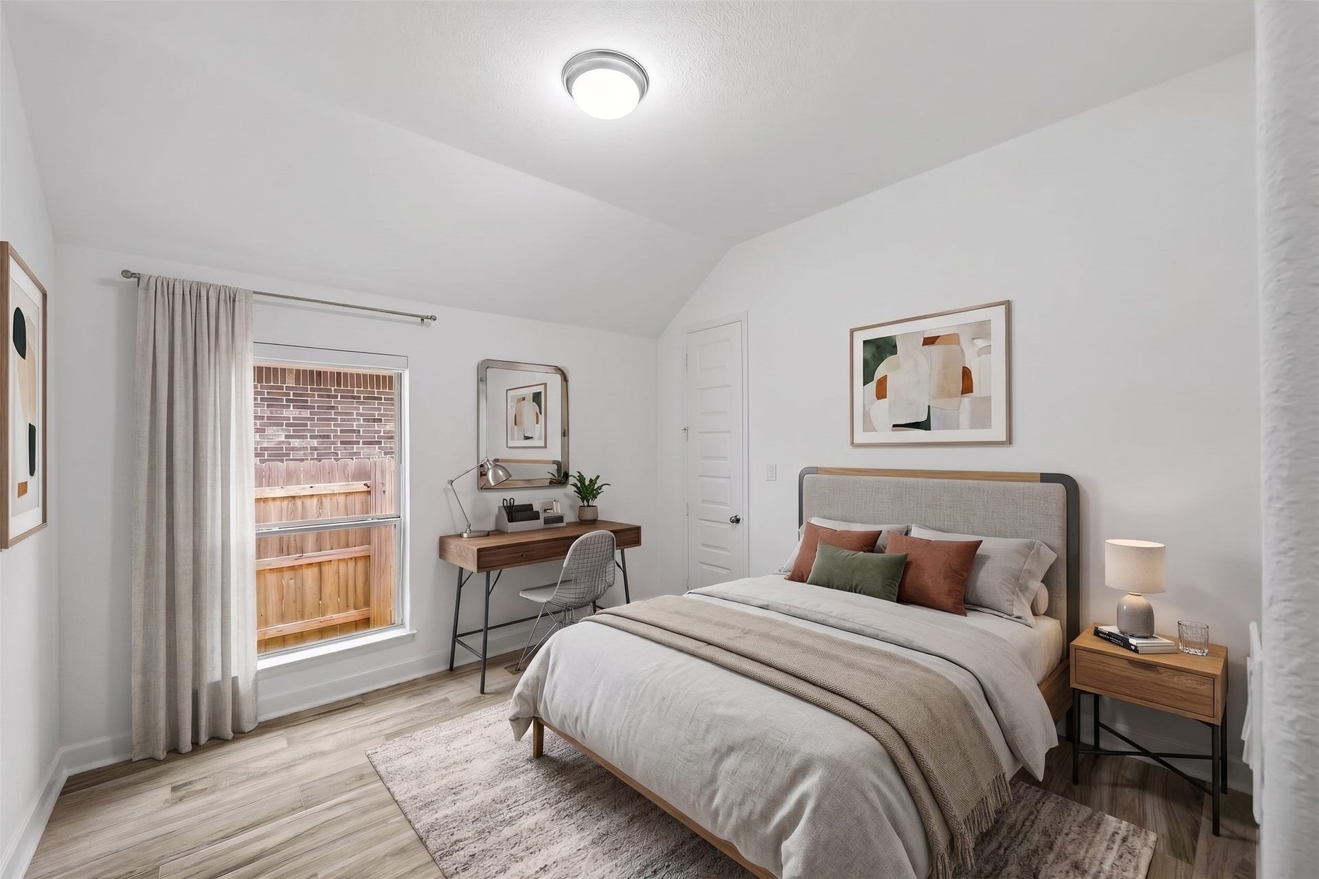 24919 Hibiscus Garden Way, Katy, TX 77493 Virtually Staged: This secondary bedroom features vaulted ceilings and wood-style flooring, creating an open and balanced atmosphere. A tall exterior window provides abundant natural light, highlighting the room's generous proportions and clean layout.