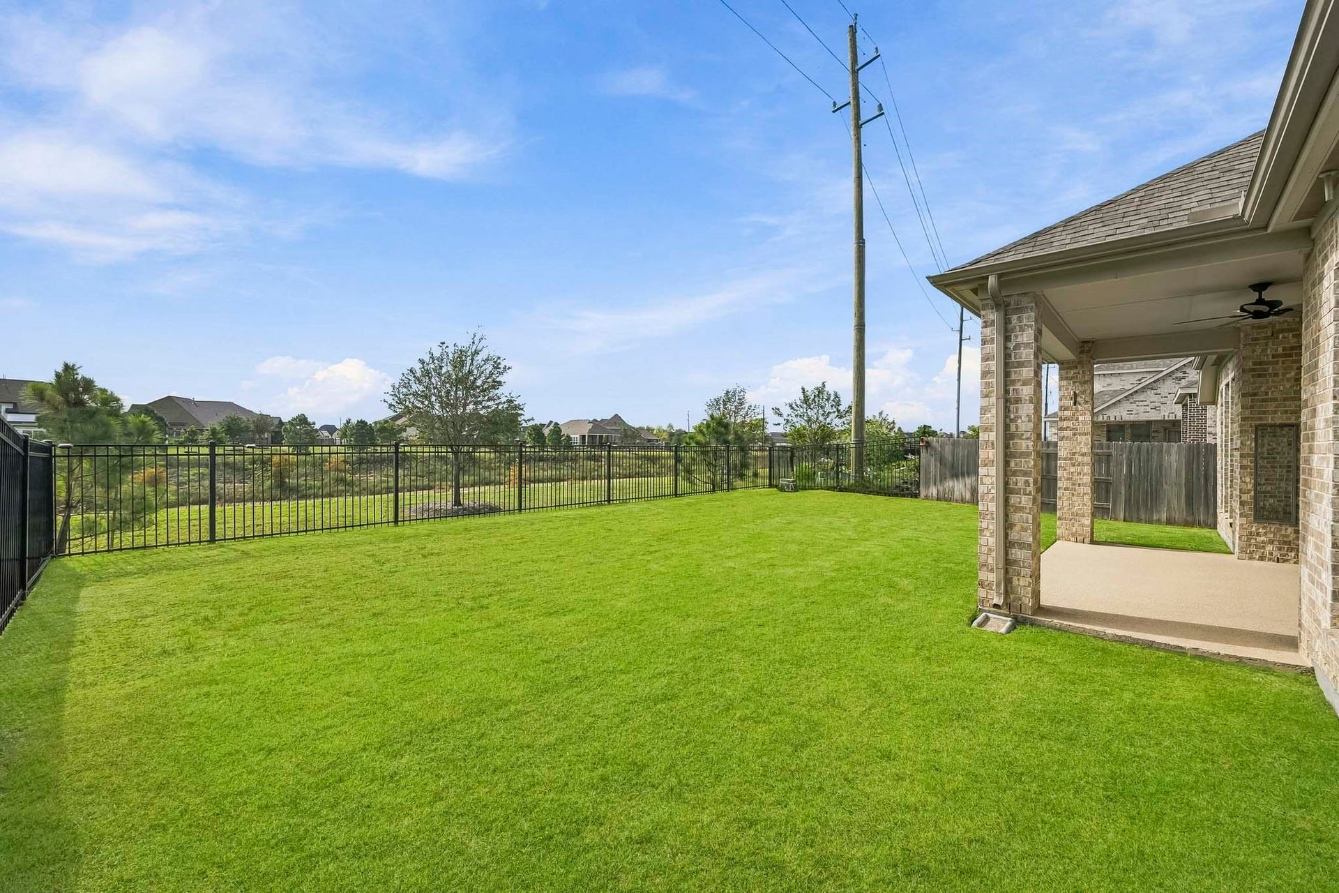 24919 Hibiscus Garden Way, Katy, TX 77493 Looking across the yard toward the home, this perspective underlines the connectivity and openness of the private outdoor space.
