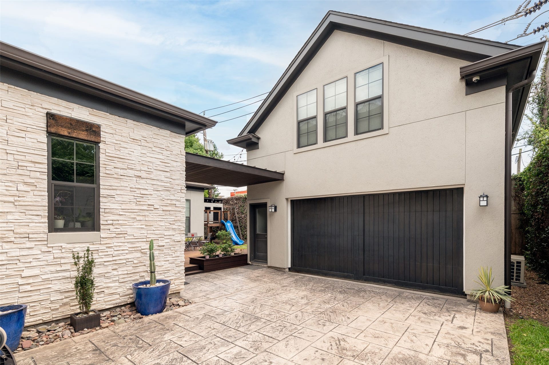Driveway space behind the gate is great for secure children's play area. Guest quarters is above garage.