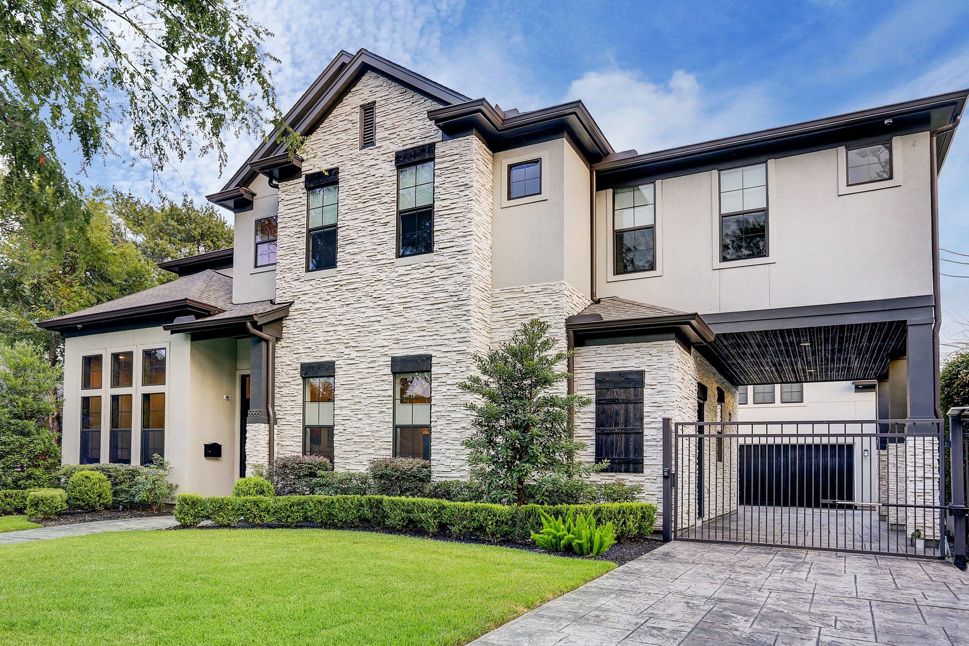 Driveway has an automatic gate and porte-cochere with door into kitchen.