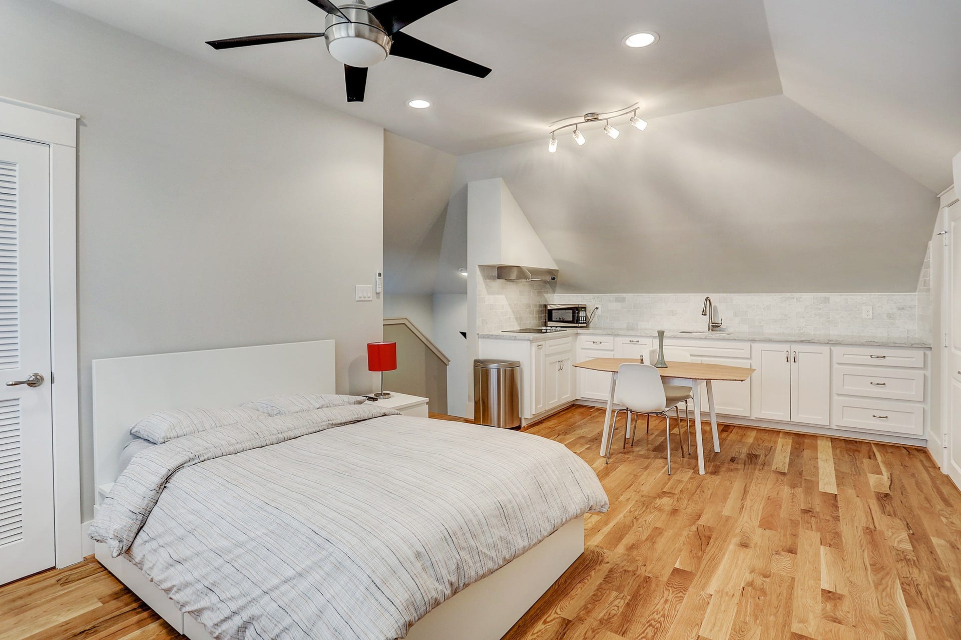 12x19 guest quarters has a private bath as well as a kitchen that includes a Bosch electric 4-burner cook top, Carrara marble counter, and directional lighting.