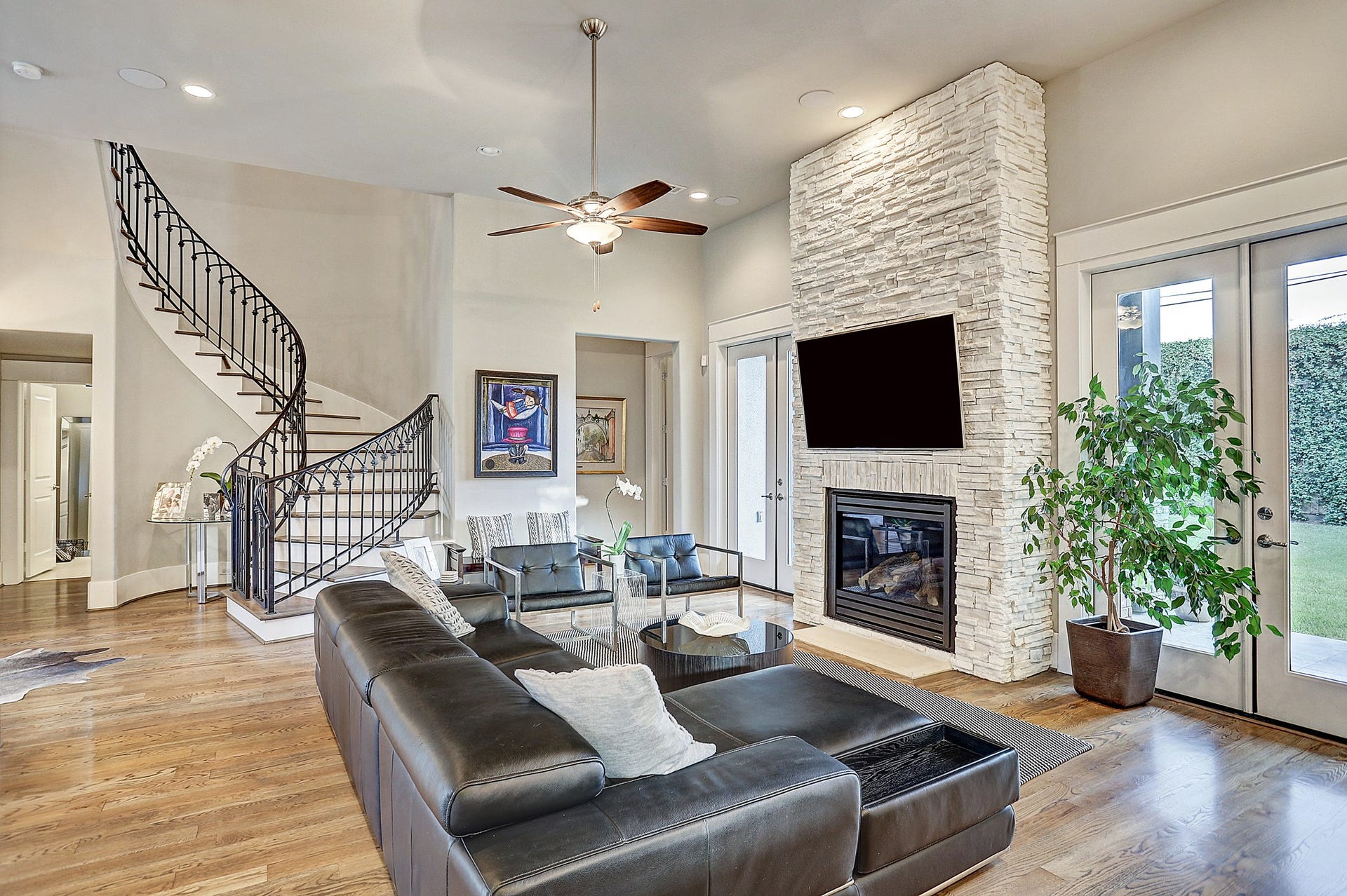 Lliving room has high ceiling and two sets of double doors leading to the back yard.