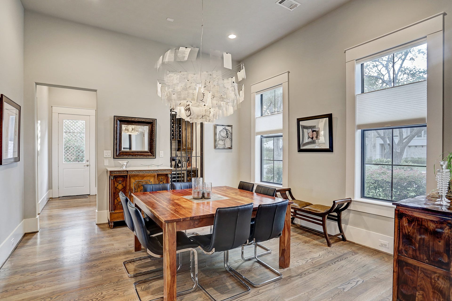 13x14 dining room has designer chandelier and recessed lighting. At back of this photo are the wine grotto and butler's pantry.