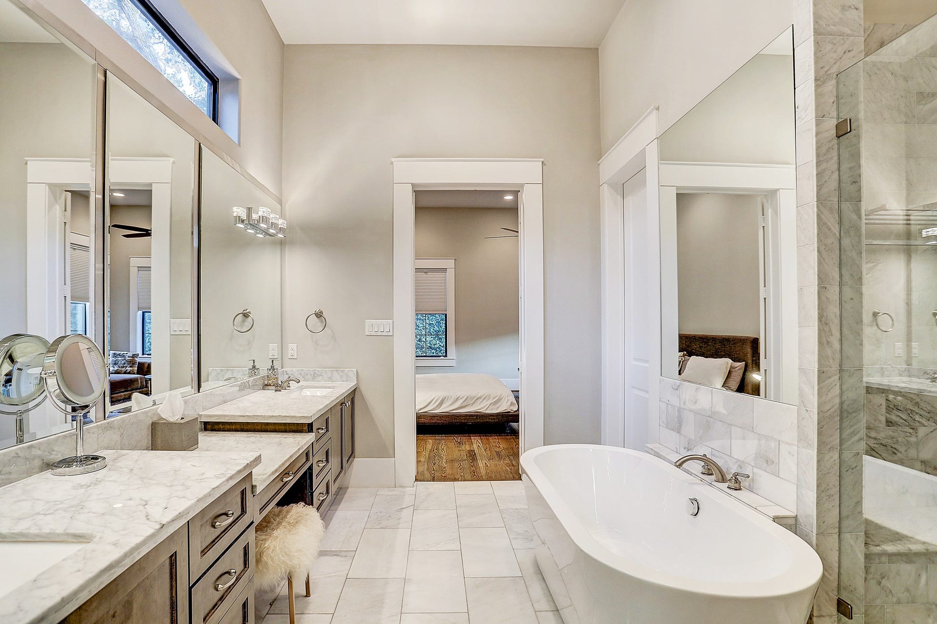 Master bath has a soaking tub with marble tile backsplash.