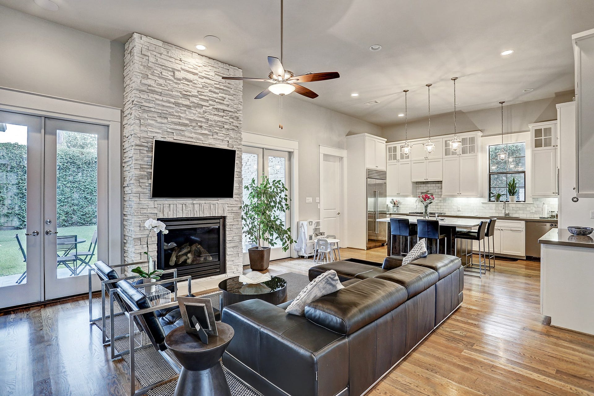 18x20 living room has gaslog fireplace with stacked stone facing. This great room also has a ceiling fan with light kit and recessed lighting.
