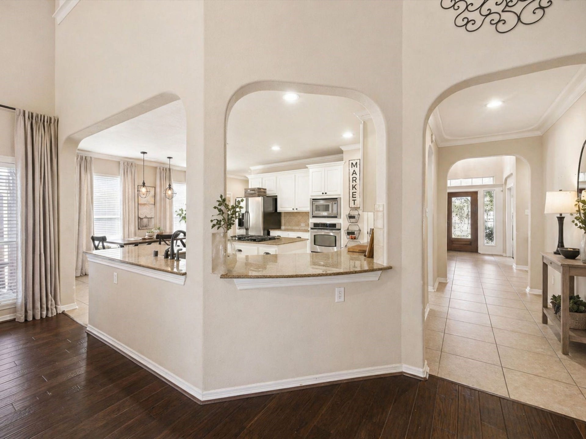 2202 SUMMER WIND DRIVE, Sugar Land, TX 77479 OPEN KITCHEN WITH BREAKFAST BAR OVERLOOKING THE LIVING ROOM, CREATING A CONNECTED AND INVITING SPACE.
