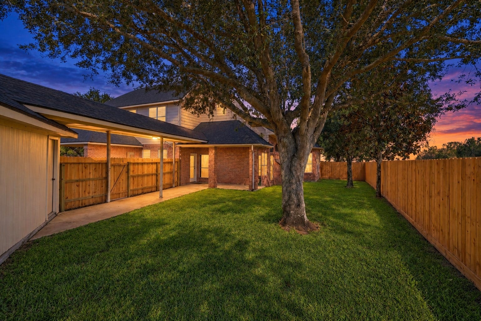 2202 SUMMER WIND DRIVE, Sugar Land, TX 77479 SPACIOUS BACKYARD WITH MATURE SHADE TREE AND LARGE GRASS AREA, PERFECT FOR OUTDOOR ENJOYMENT.