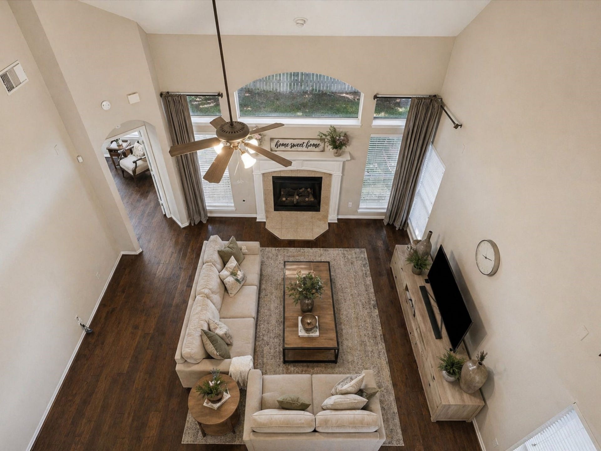 2202 SUMMER WIND DRIVE, Sugar Land, TX 77479 DRAMATIC TWO-STORY LIVING ROOM WITH SOARING CEILINGS, FLOOR-TO-CEILING WINDOWS, AND A CENTRAL FIREPLACE. OPEN LAYOUT PERFECT FOR ENTERTAINING.