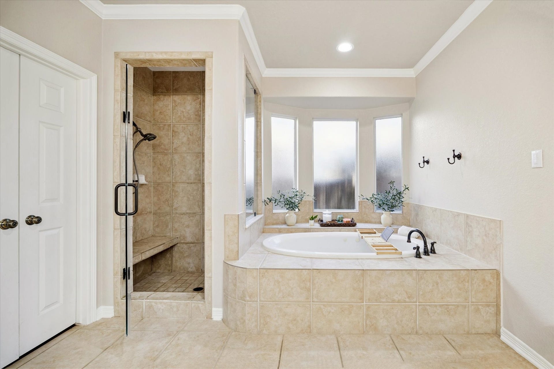 2202 SUMMER WIND DRIVE, Sugar Land, TX 77479 LUXURIOUS SOAKING TUB WITH SEPARATE WALK-IN SHOWER AND NATURAL LIGHT FROM FROSTED WINDOWS FOR PRIVACY. A TRUE SPA-LIKE RETREAT.
