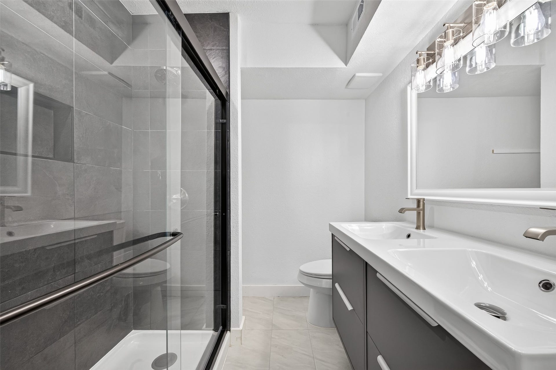 4633 Wild Indigo Street, #530, Houston, TX 77027 Contemporary vanity with double sinks, streamlined cabinetry, and carefully coordinated fixtures creates a fresh, polished bathroom retreat.