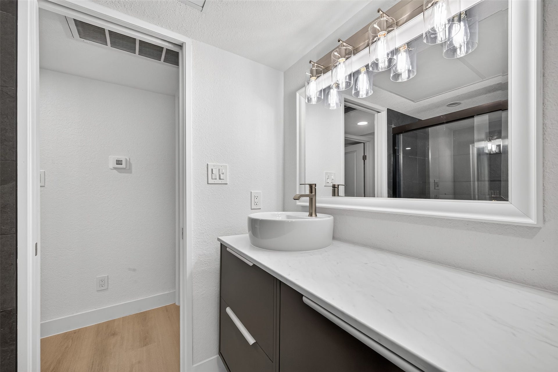 4633 Wild Indigo Street, #530, Houston, TX 77027 Beautifully renewed bathroom featuring updated tile, contemporary fixtures, a modern vanity, and a clean, timeless design.