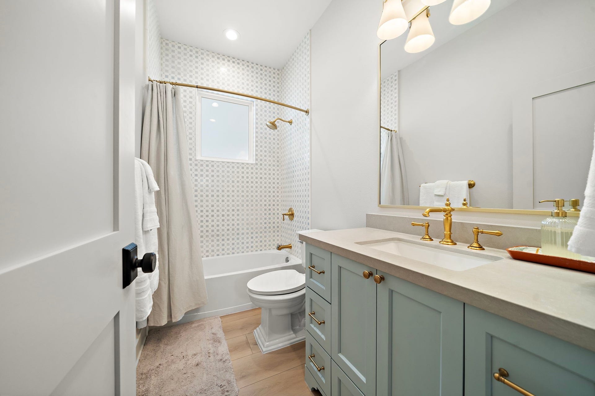 1825 Avenue N Street, Galveston, TX 77550 First bathroom at the front of the home with a tub/shower combo, Kohler finishes, and cabinets & drawers providing plenty of storage space.