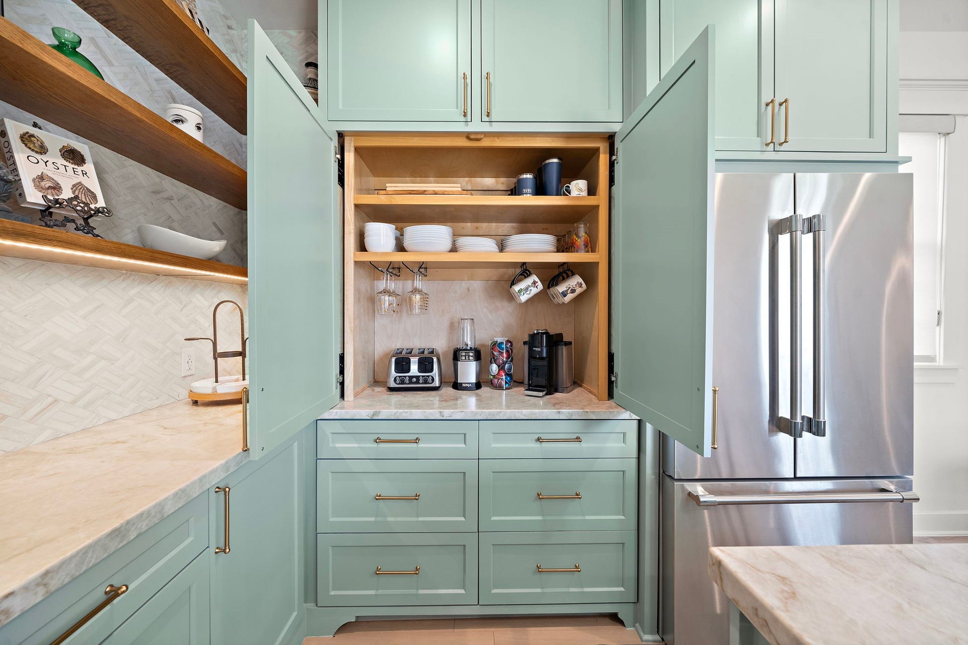 1825 Avenue N Street, Galveston, TX 77550 A dedicated built-in coffee bar in the kitchen, with drawers that provides for storage and stainless steel fridge.