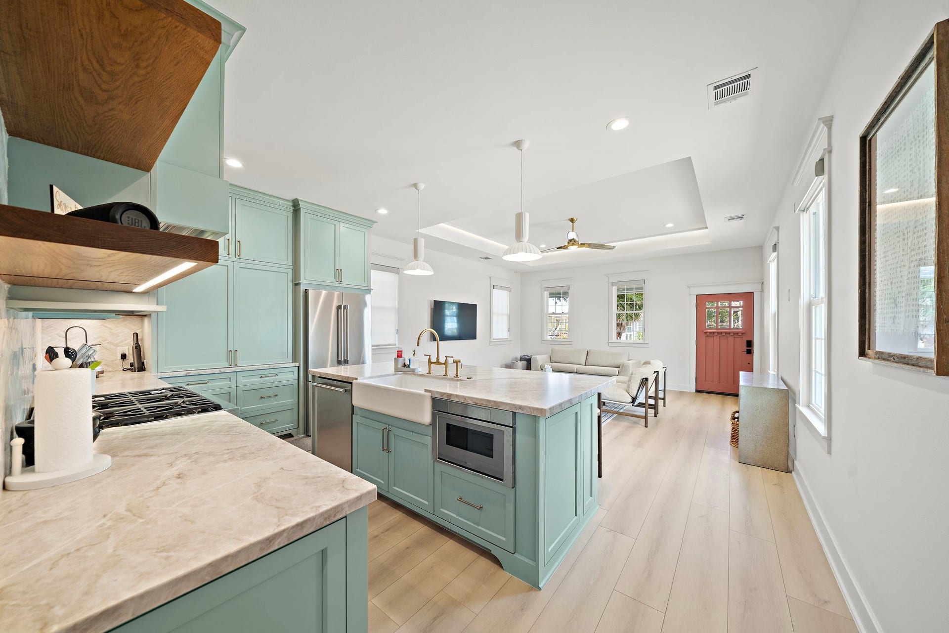 1825 Avenue N Street, Galveston, TX 77550 Kitchen has Thermodor gas double oven, under mount microwave, dishwasher, and fridge. Custom coffee bar is located behind large cabinet doors.