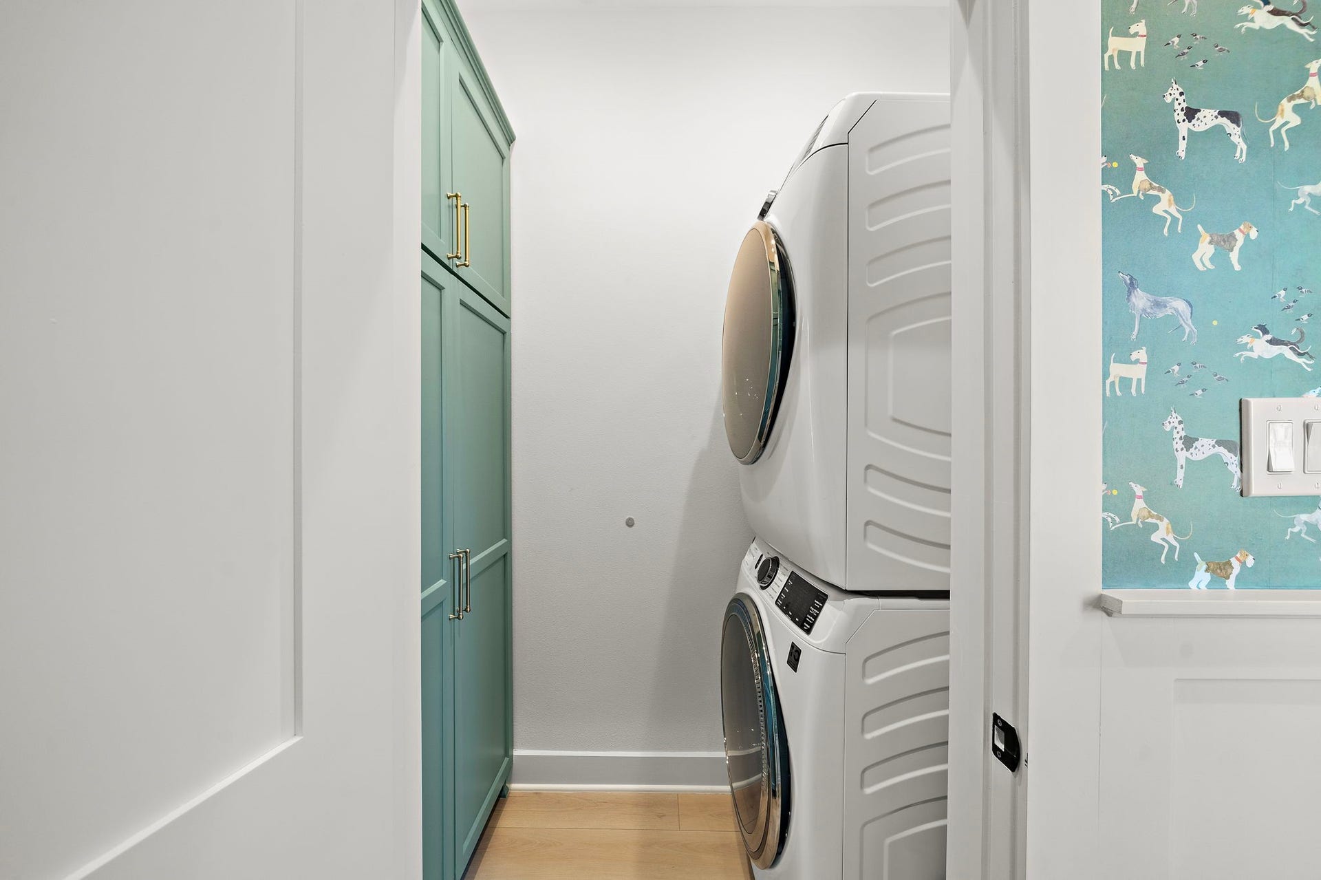1825 Avenue N Street, Galveston, TX 77550 Utility room with full size washer/dryer and built-in cabinets for storage. No detail was left behind - outlet for vacuum located behind cabinet door.