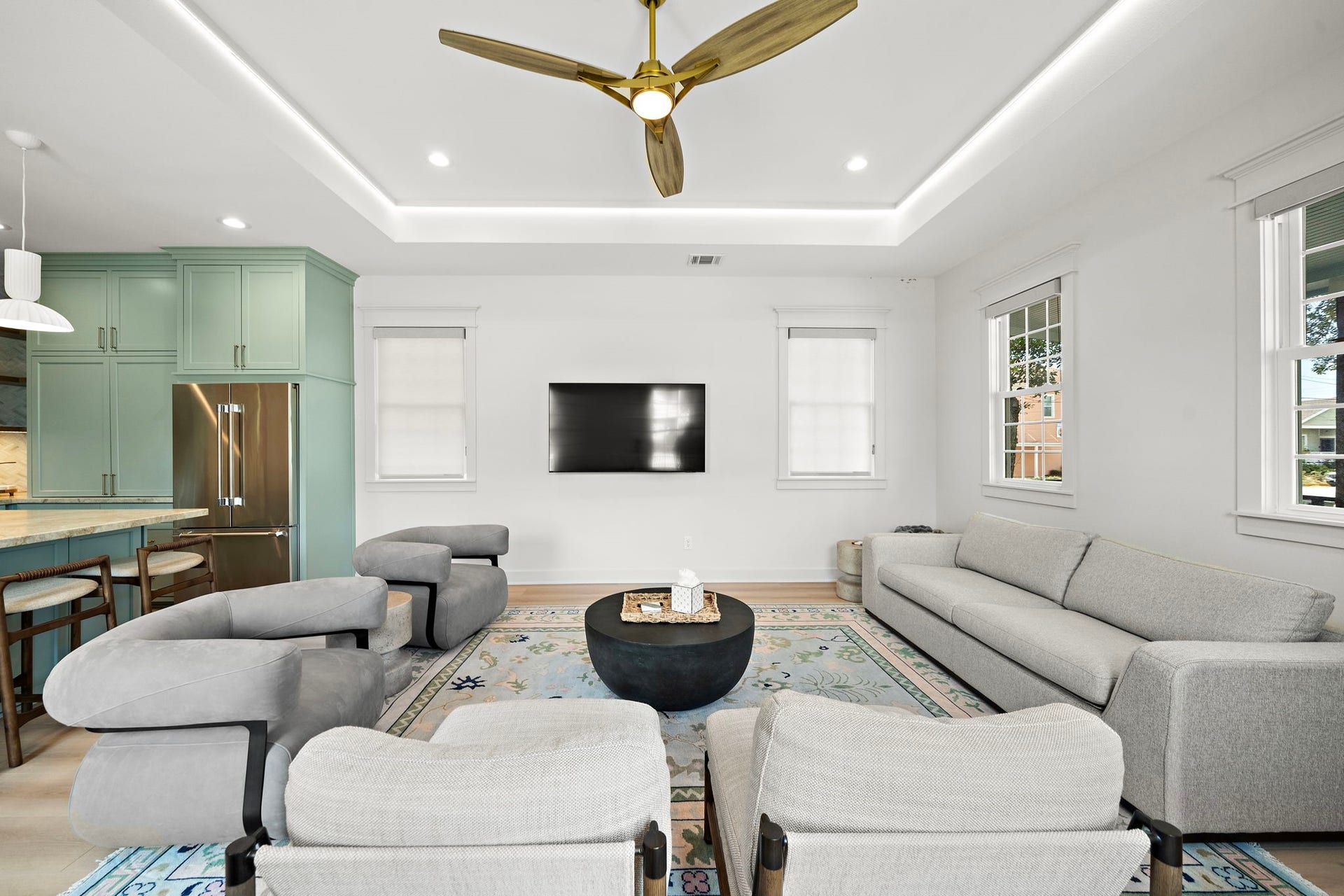 1825 Avenue N Street, Galveston, TX 77550 Spacious living room with recessed ceiling with rope lighting, Miele fan, and tons of natural lighting.