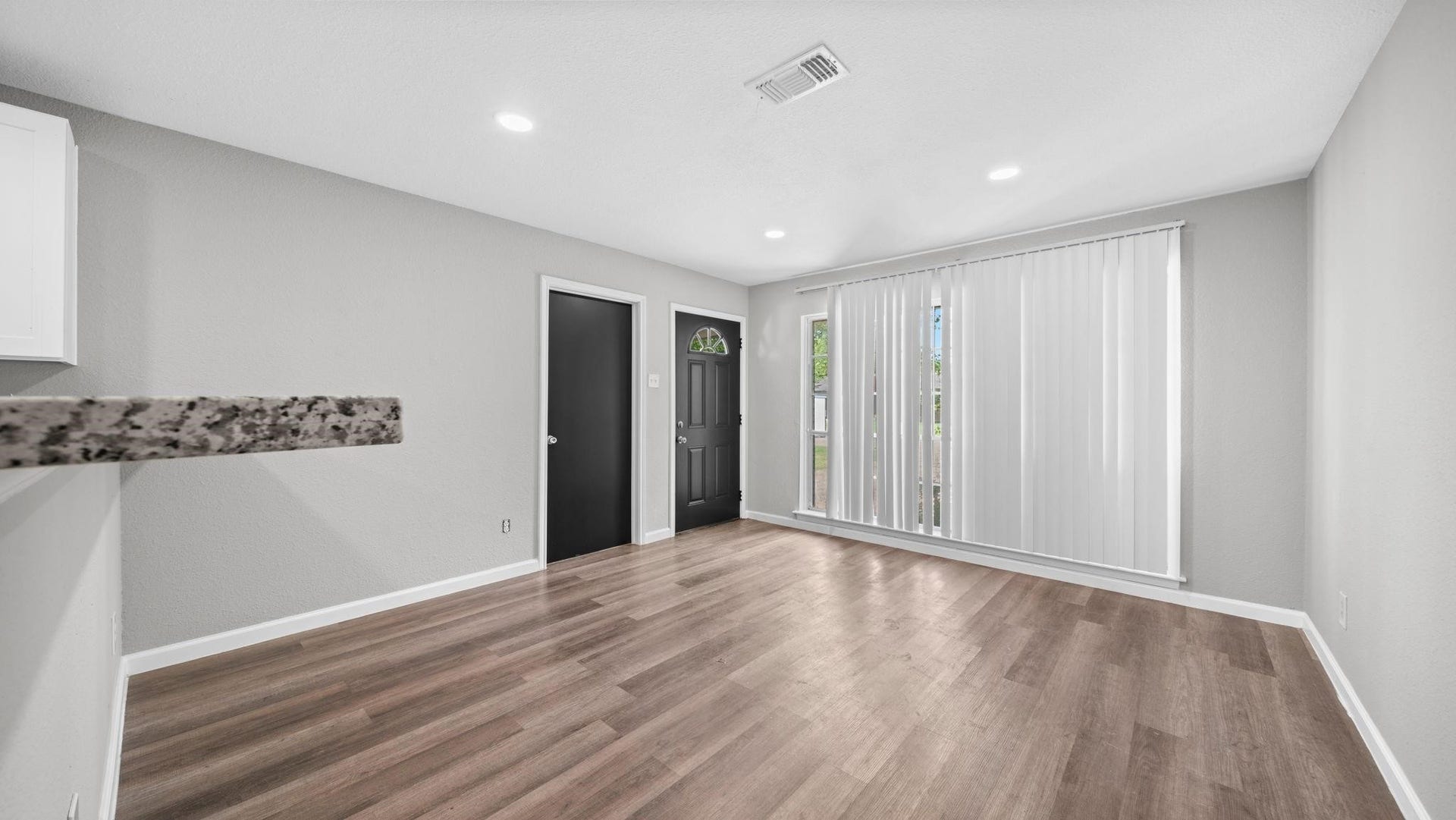 5242 Greylog Drive, Houston, TX 77048 Recessed lighting casts a warm, inviting glow throughout the open-concept living space, highlighting its seamless flow between the kitchen and living areas while creating an elegant atmosphere for both relaxed living and sophisticated entertaining.