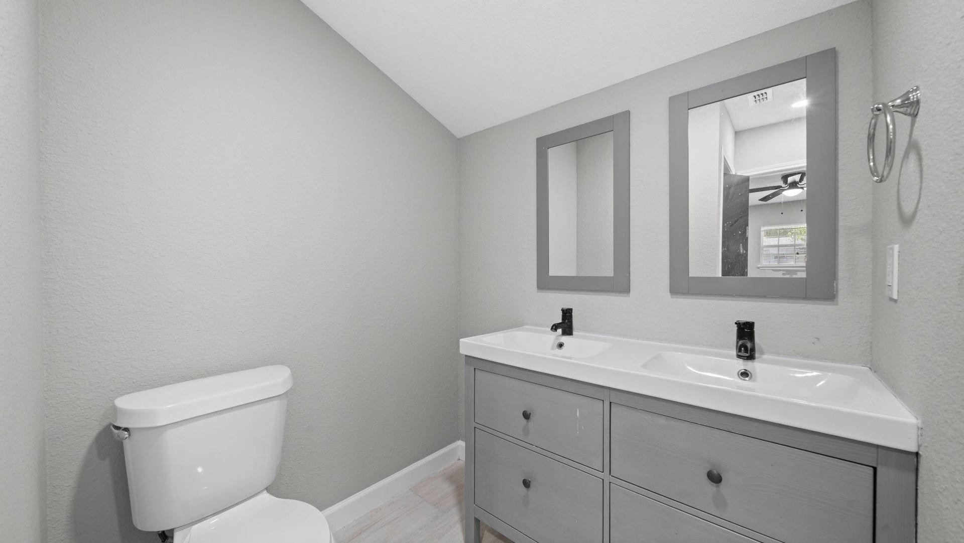 5242 Greylog Drive, Houston, TX 77048 The primary bath features tile flooring and a conveniently located closet, offering additional storage and organization while complementing the suites comfort and functionality.