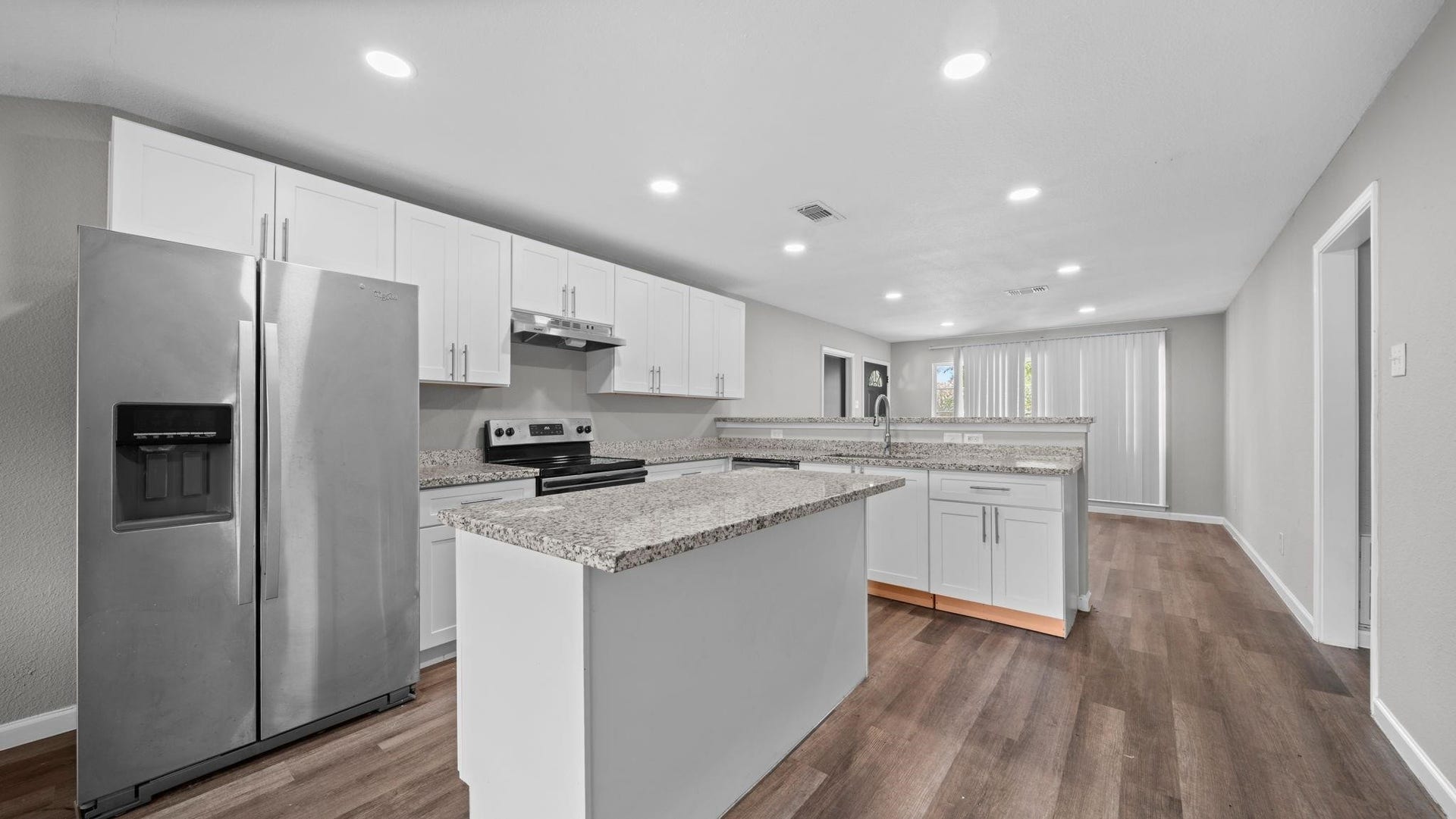 5242 Greylog Drive, Houston, TX 77048 The kitchen features a suite of stainless steel appliances, including a GE electric range and oven, dishwasher and a deep stainless steel sink designed to accommodate larger cookware. A Whirlpool refrigerator, included with the home, completes this beautifully appointed and functional space.