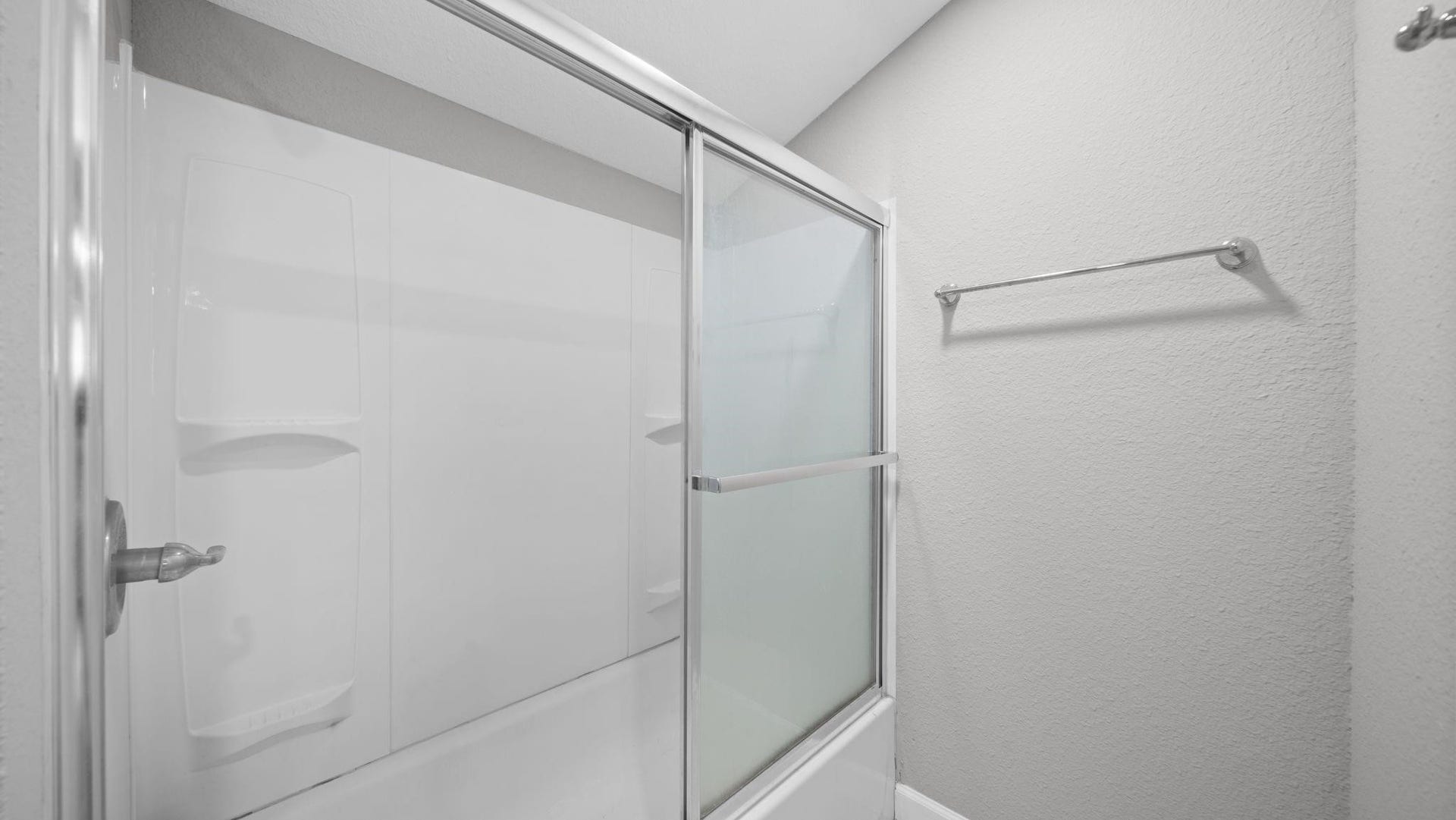 5242 Greylog Drive, Houston, TX 77048 The elegantly appointed bath features a tub and shower combination with sliding glass doors completes this beautifully designed space.