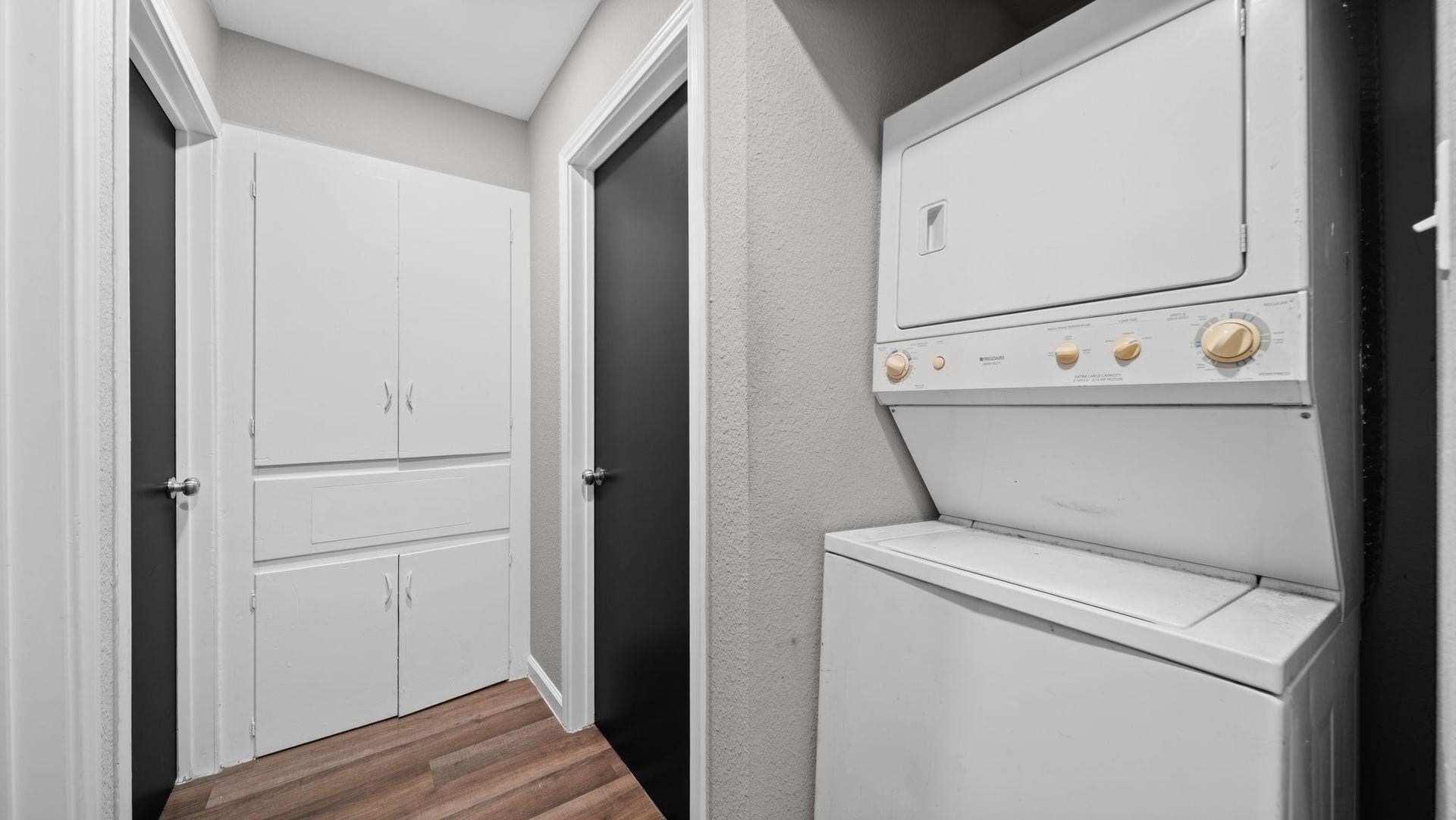 5242 Greylog Drive, Houston, TX 77048 Conveniently located off the hallway, the dedicated laundry closet features a stackable Frigidaire washer and dryer, both included with the home. This well-designed space offers practical functionality while maintaining a clean, streamlined appearance.