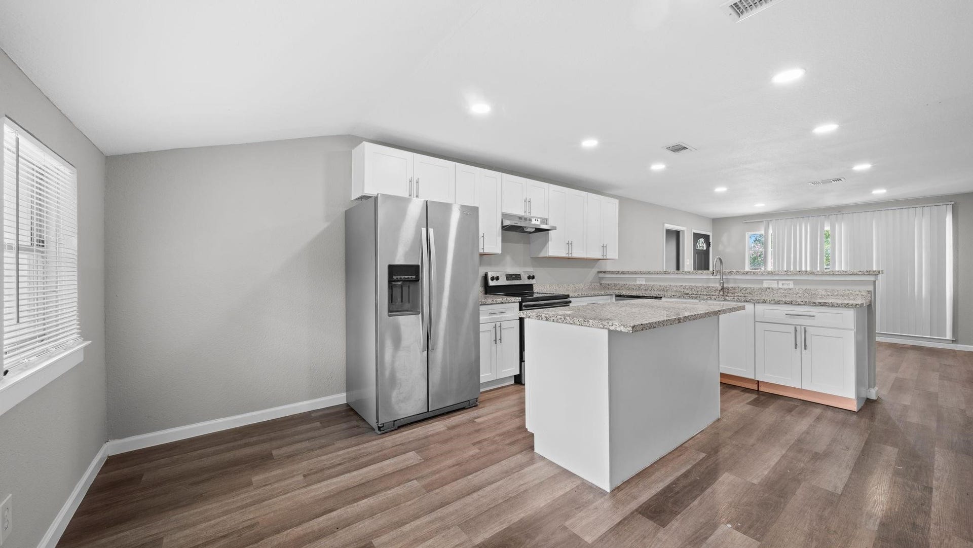 5242 Greylog Drive, Houston, TX 77048 The center island offers inviting bar seating, creating a natural gathering place where casual dining, conversation, and culinary creativity come together in a beautifully connected kitchen.