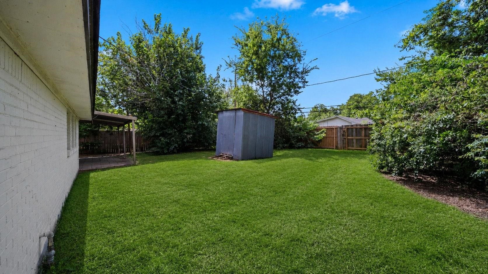 5242 Greylog Drive, Houston, TX 77048 A corrugated steel storage shed provides convenient space for tools and outdoor essentials, while an additional patio area creates an inviting setting for outdoor dining and relaxation. The expansive backyard offers endless possibilities for lush landscaping, recreation, or creating a personalized outdoor retreat.