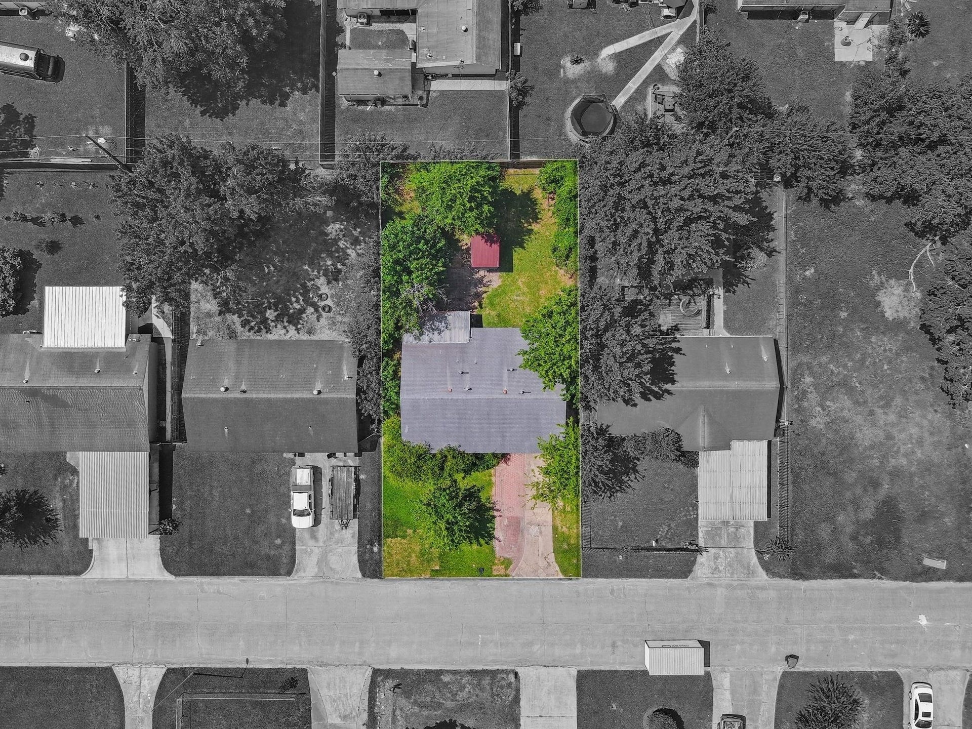 5242 Greylog Drive, Houston, TX 77048 An aerial perspective showcases the exceptional space and possibilities of the expanded backyard. Framed by mature trees, this inviting outdoor setting features a covered patio, expansive lawn, and ample room for lush gardens, recreation, or a beautifully designed outdoor oasis.