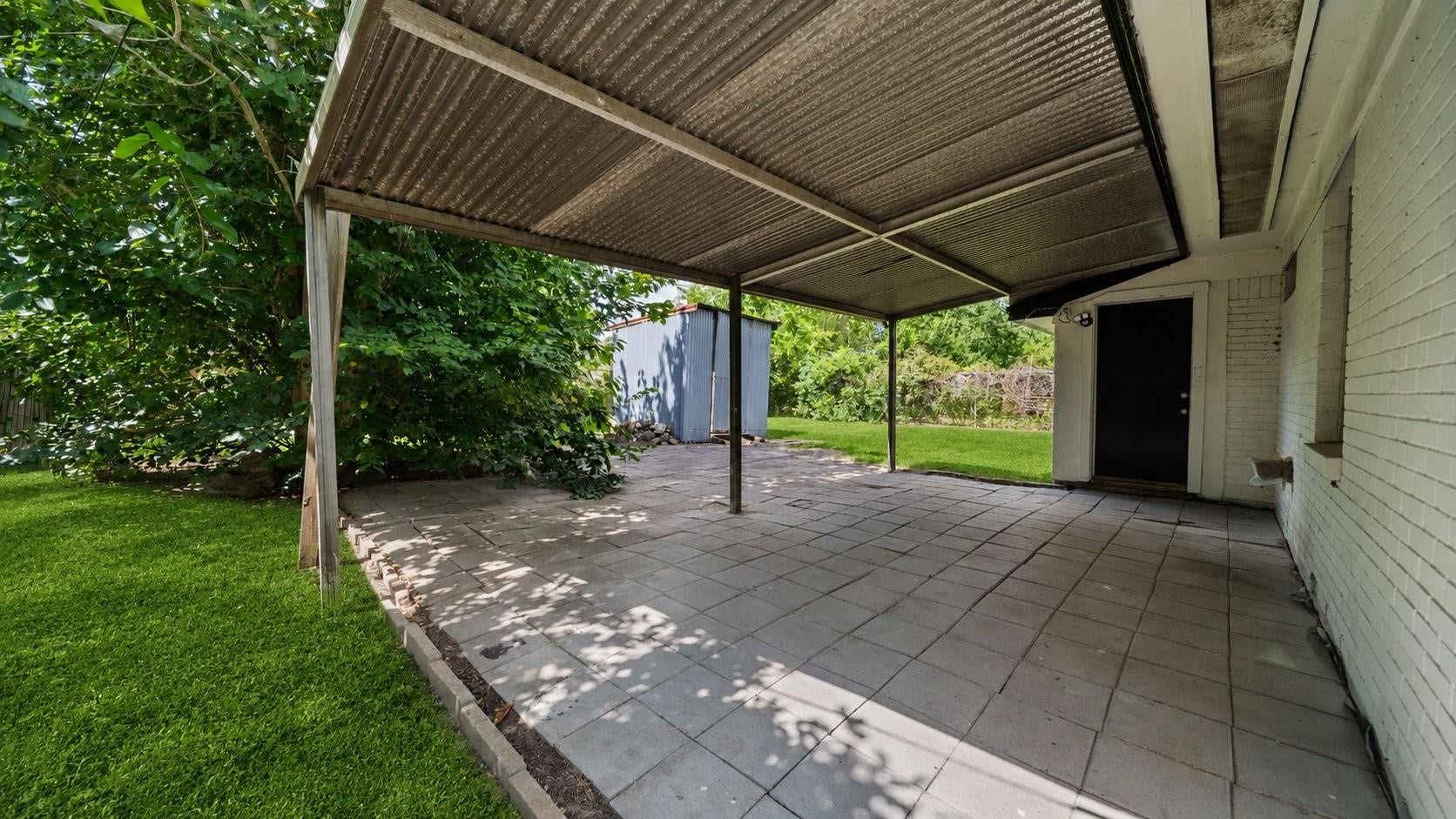 5242 Greylog Drive, Houston, TX 77048 The covered back patio, finished with attractive concrete tile flooring, offers an inviting outdoor retreat for enjoying morning coffee, hosting weekend gatherings, or simply relaxing in the fresh air. Its sheltered design provides a comfortable extension of the home's living space, perfect for year-round enjoyment.
