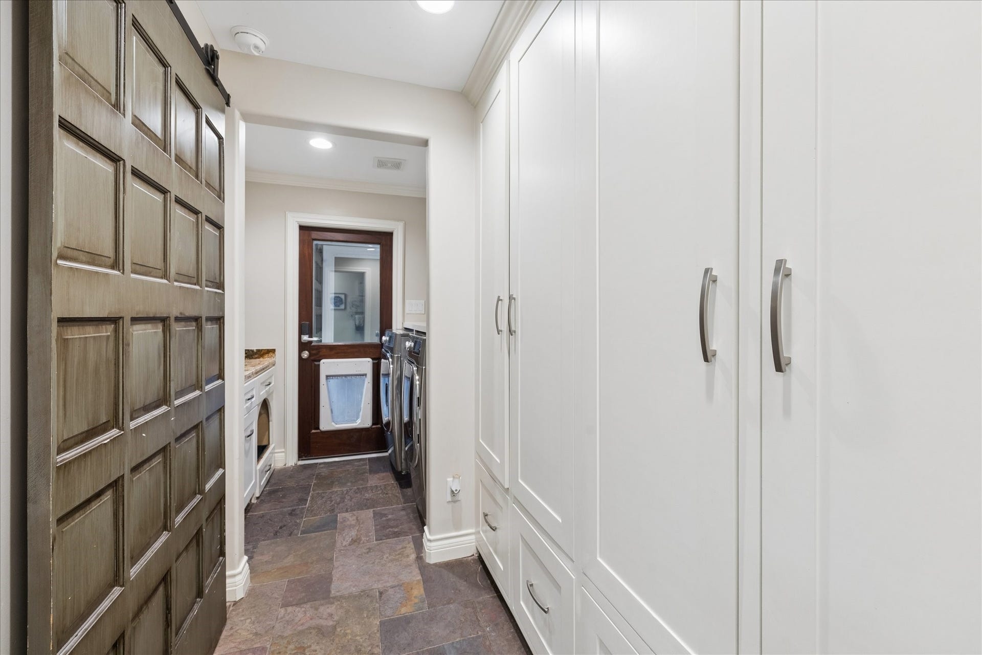 13723 Taylorcrest Road, Houston, TX 77079 Mudroom with lockers and laundry room with folding counter. Door in background leading to garage.