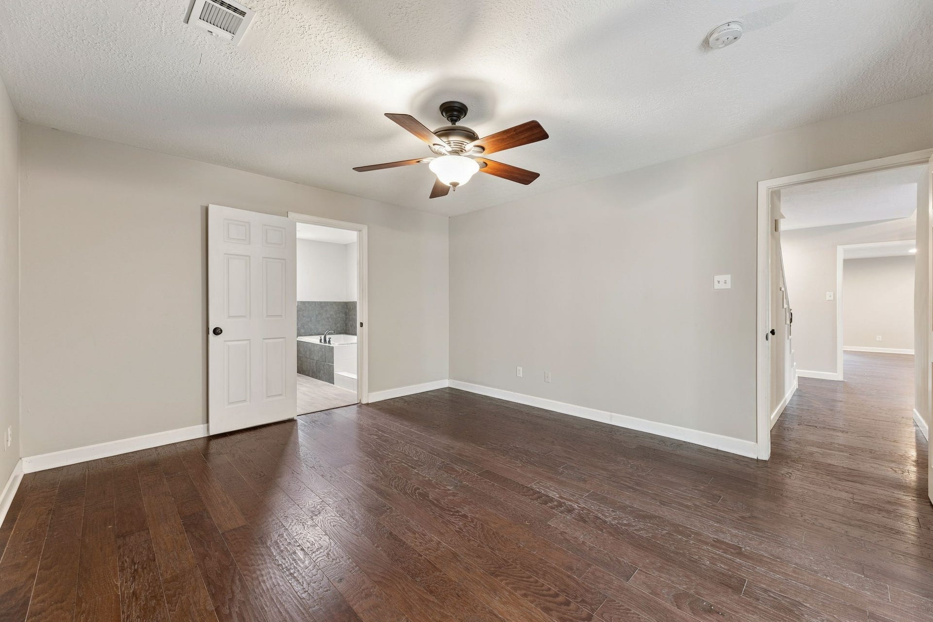 4411 Deerfield Village Drive, Houston, TX 77084 Spacious downstairs primary bedroom with wood flooring!