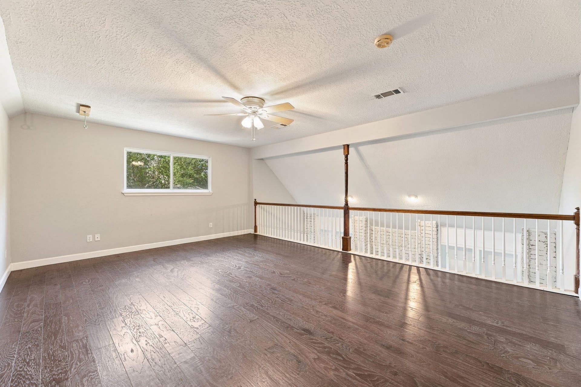 4411 Deerfield Village Drive, Houston, TX 77084 Open and airy upstairs game room with beautiful wood flooring!