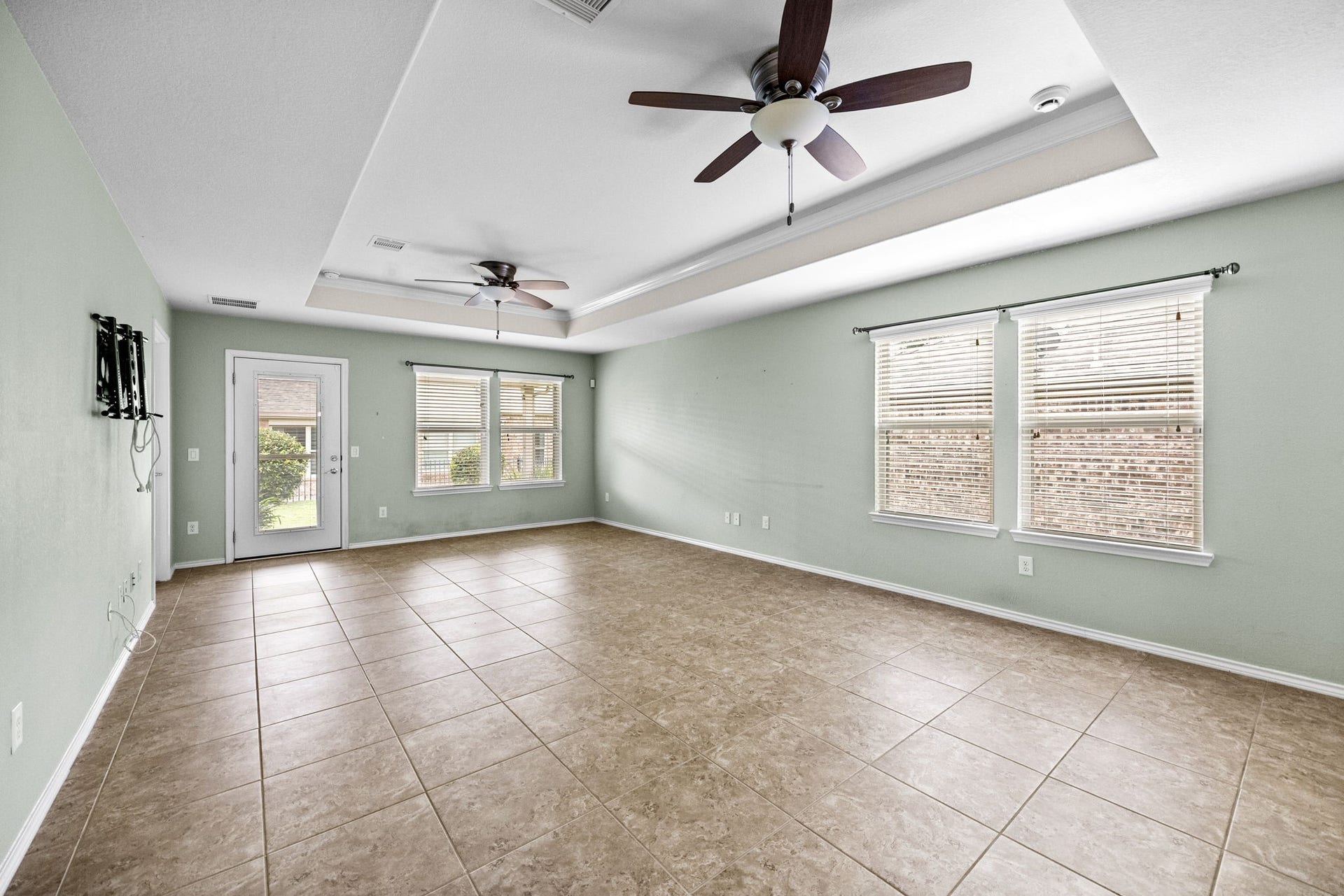 Home has white blinds throughout, tray ceilings in two room and 17 inch tile in all areas except bedrooms