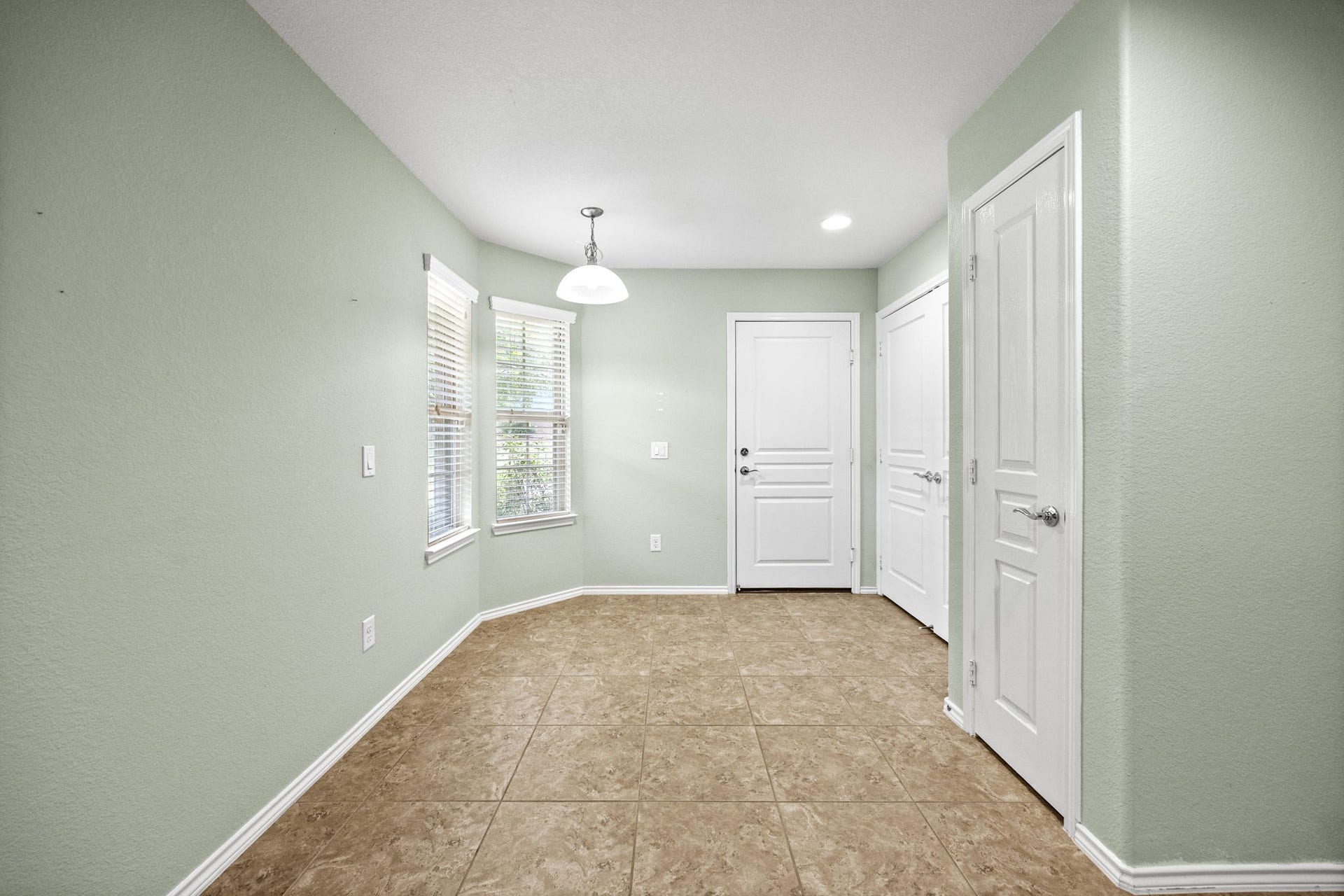 Breakfast area, right doors are the pantry, utility room and back door leads to garage.