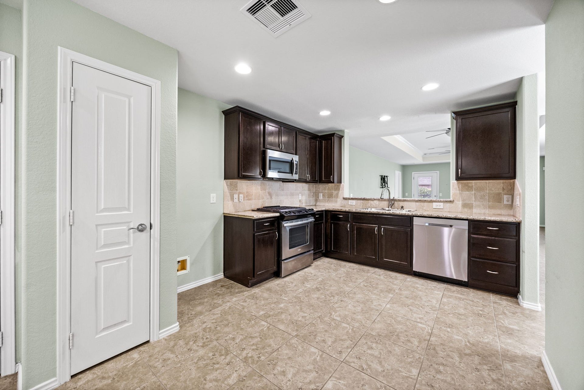 Kitchen area has a nice view into the Living area. This view is from the Breakfast area.