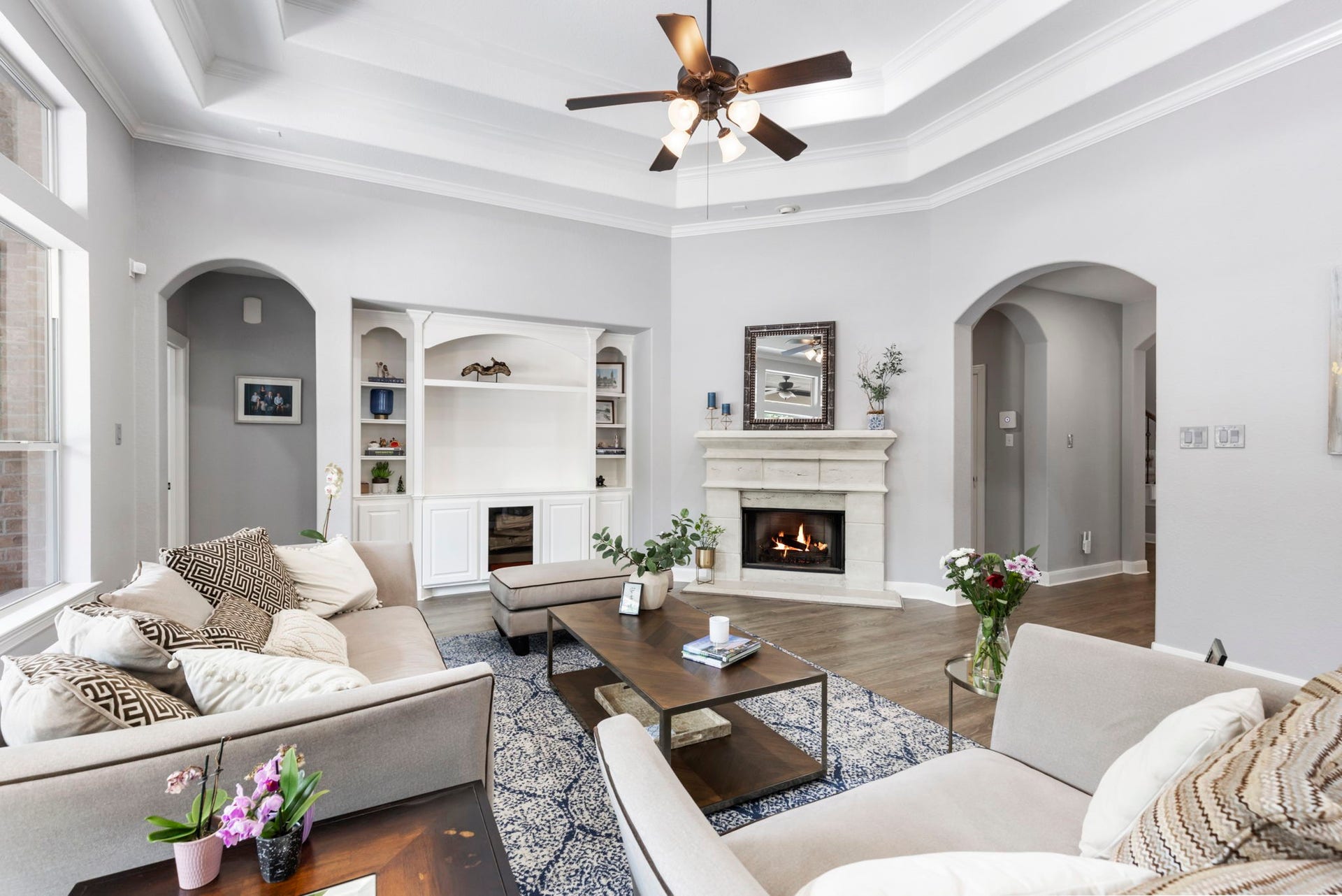 130 S Arrow Canyon Circle, The Woodlands, TX 77389 Another view of this living room with a cozy fireplace and built-in shelving.