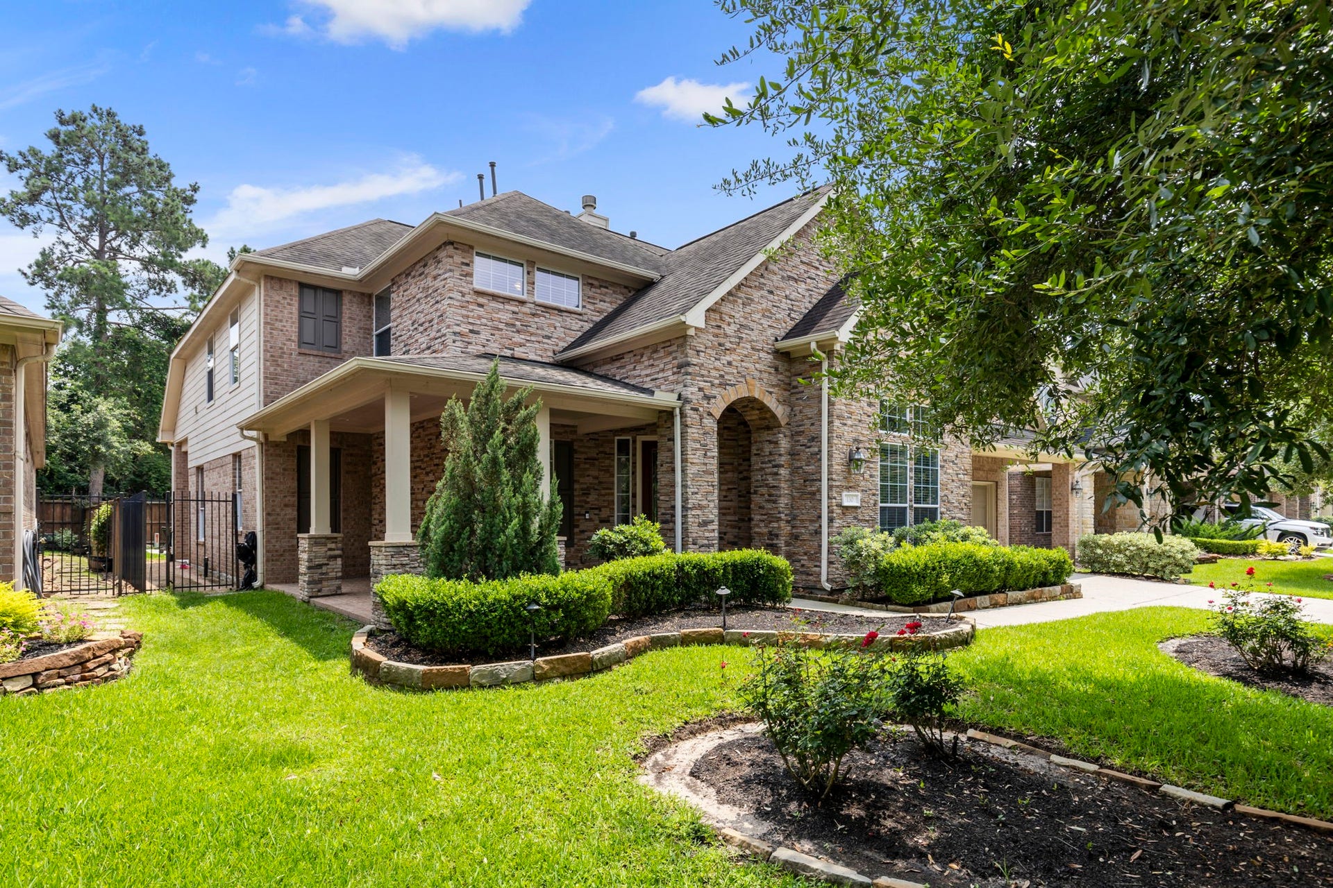 130 S Arrow Canyon Circle, The Woodlands, TX 77389 Charming two-story brick home with nice elevation and showing the large front covered porch