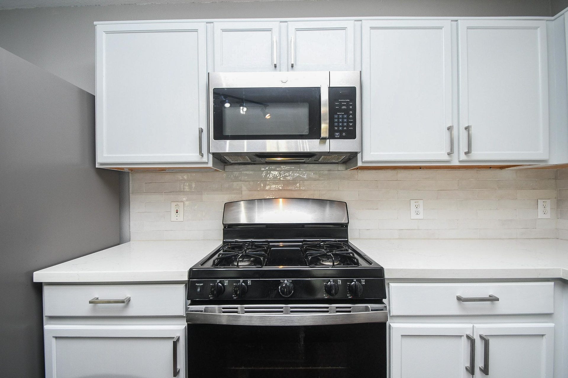10222 Antelope Alley, Missouri City, TX 77459 Modern kitchen featuring sleek stainless steel appliances, pristine white cabinetry, and a stylish subway tile backsplash.