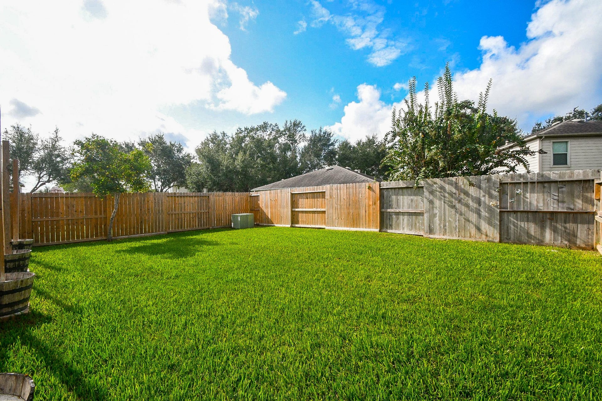 10222 Antelope Alley, Missouri City, TX 77459 Spacious backyard with lush green lawn, perfect for outdoor activities, surrounded by a secure wooden fence for privacy.